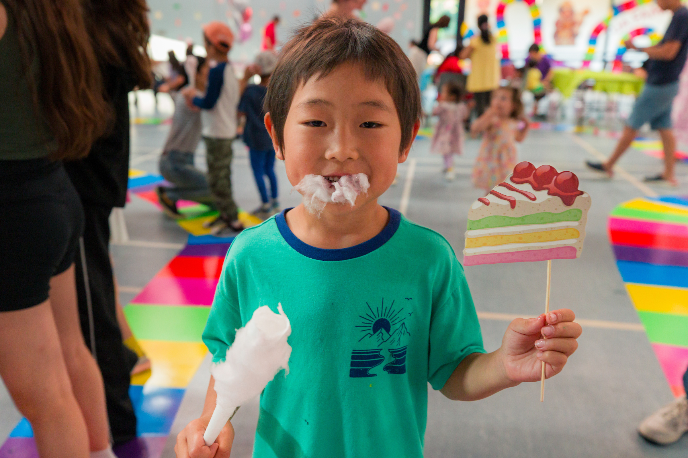Little boy eating cotton candy and smiling
