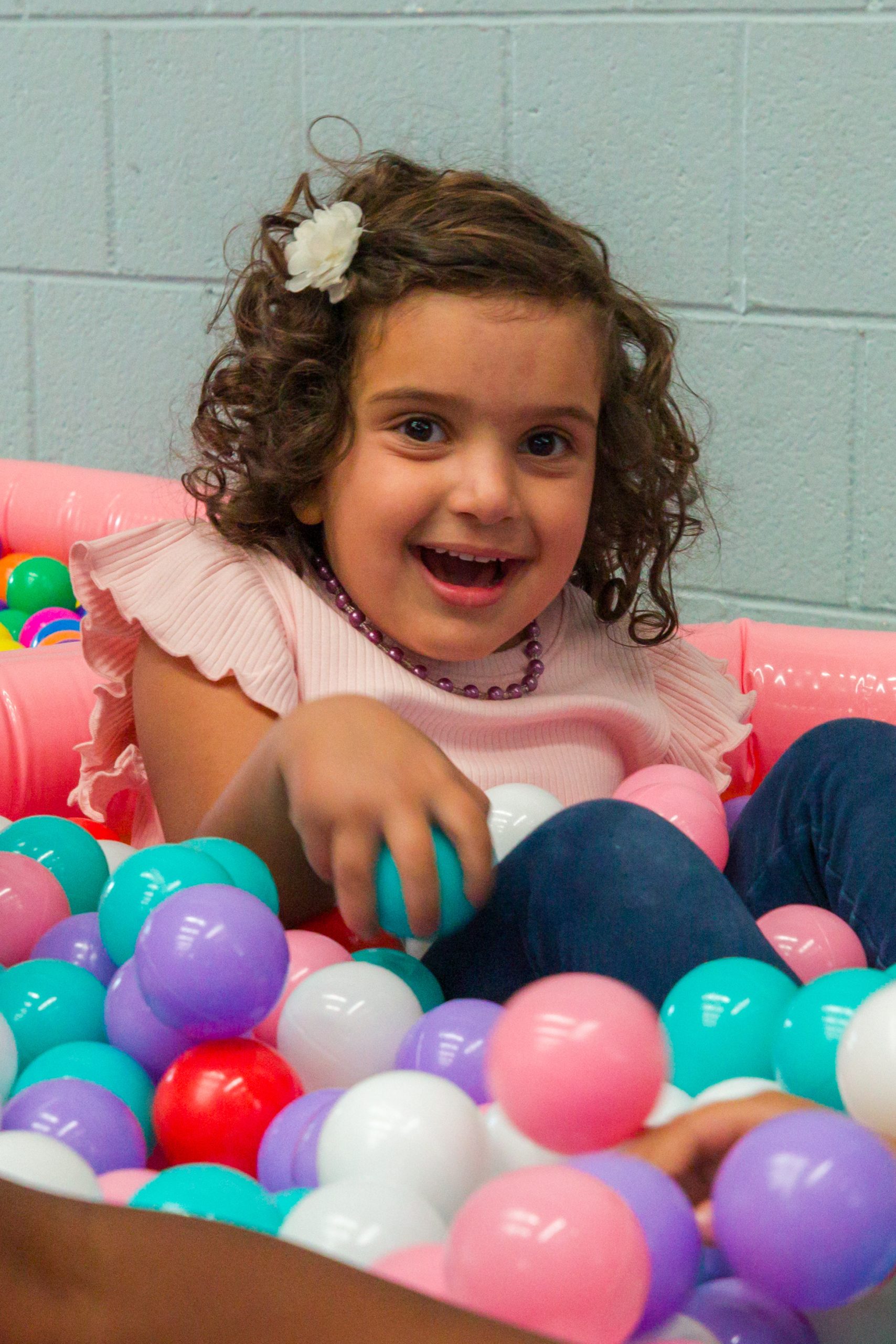 Little girl in ball pit