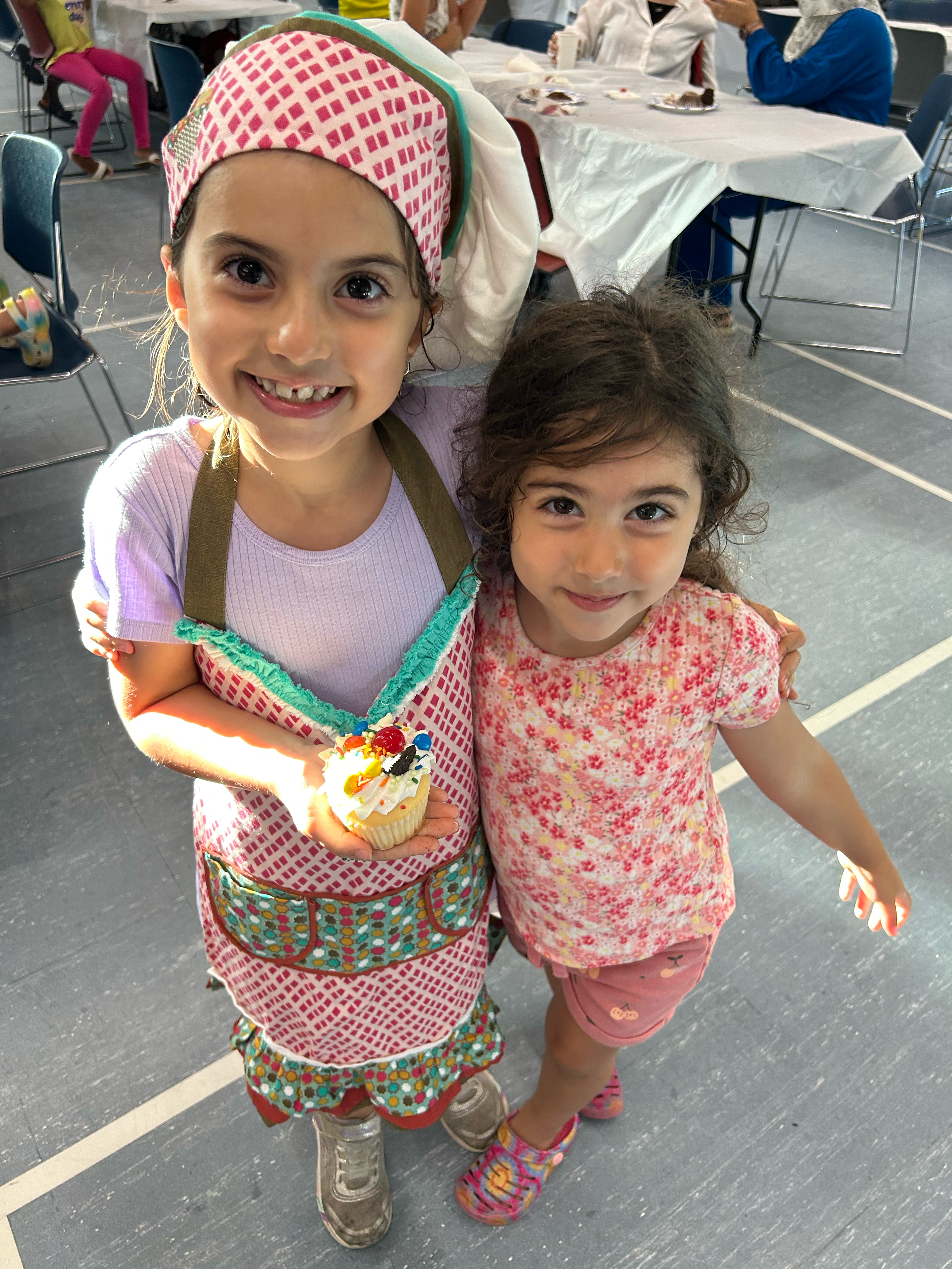 Two young girls smiling at the camera