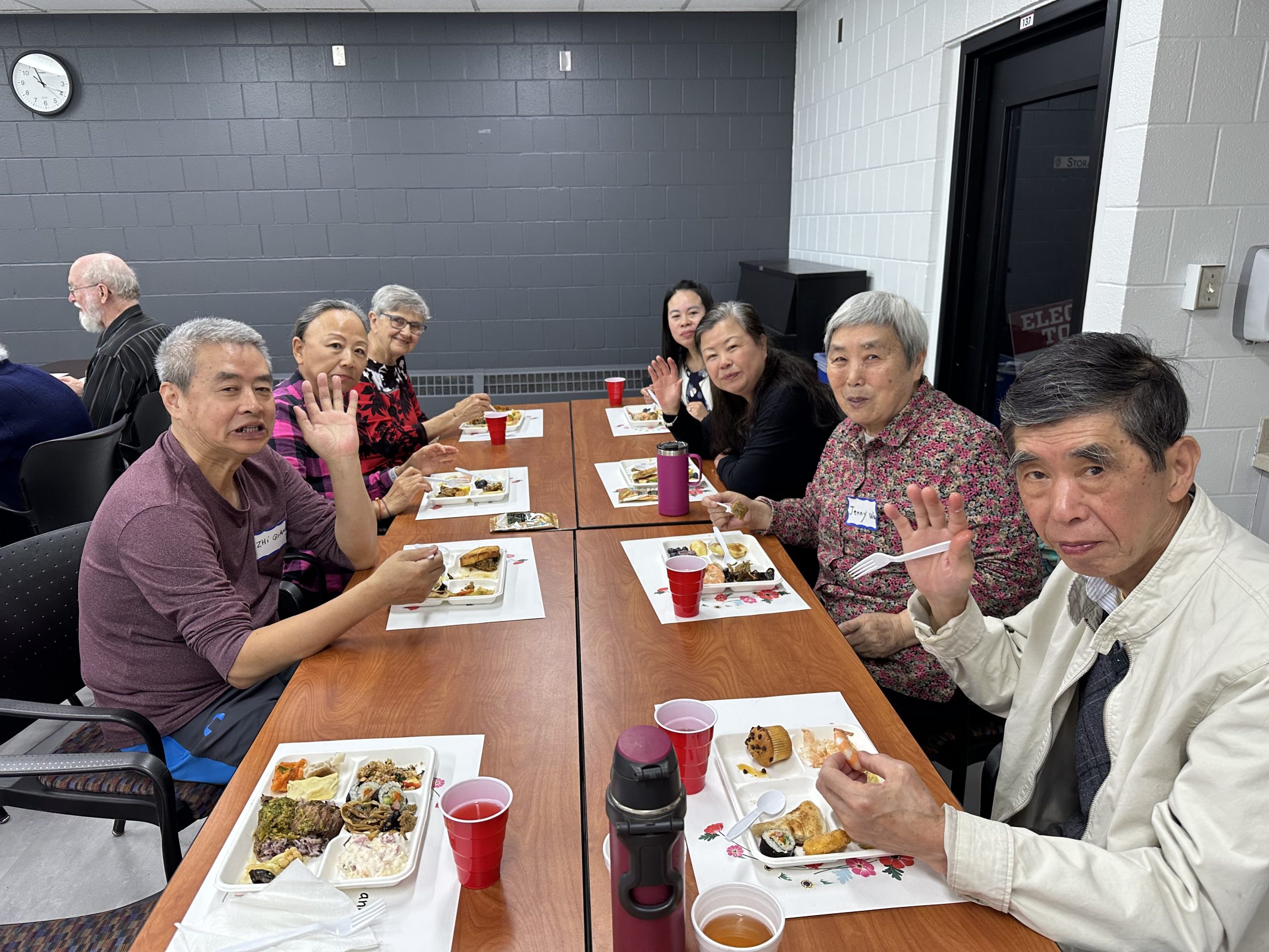 Group of people eating potluck food