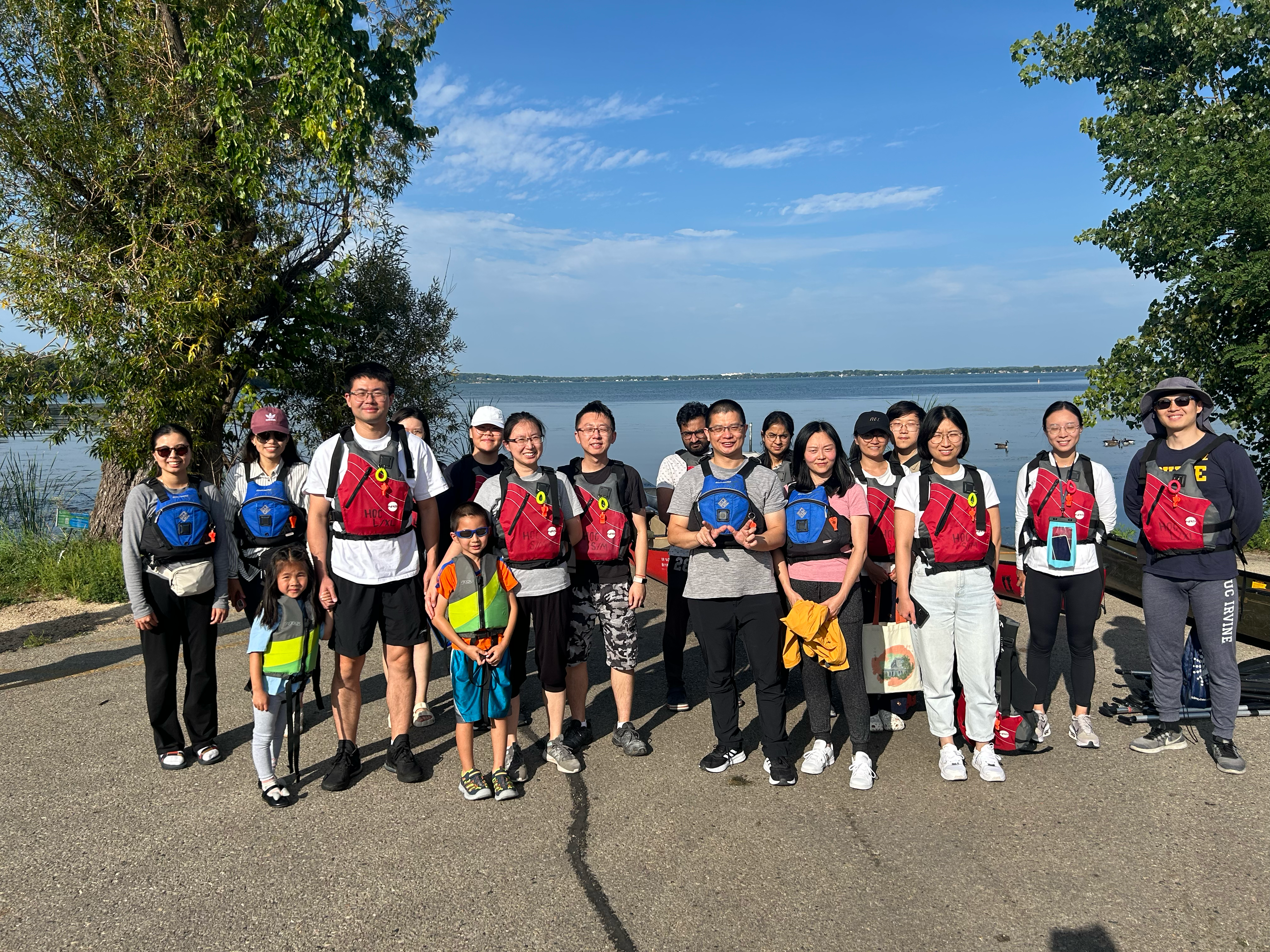 Group of people who went canoeing with the lake in the background