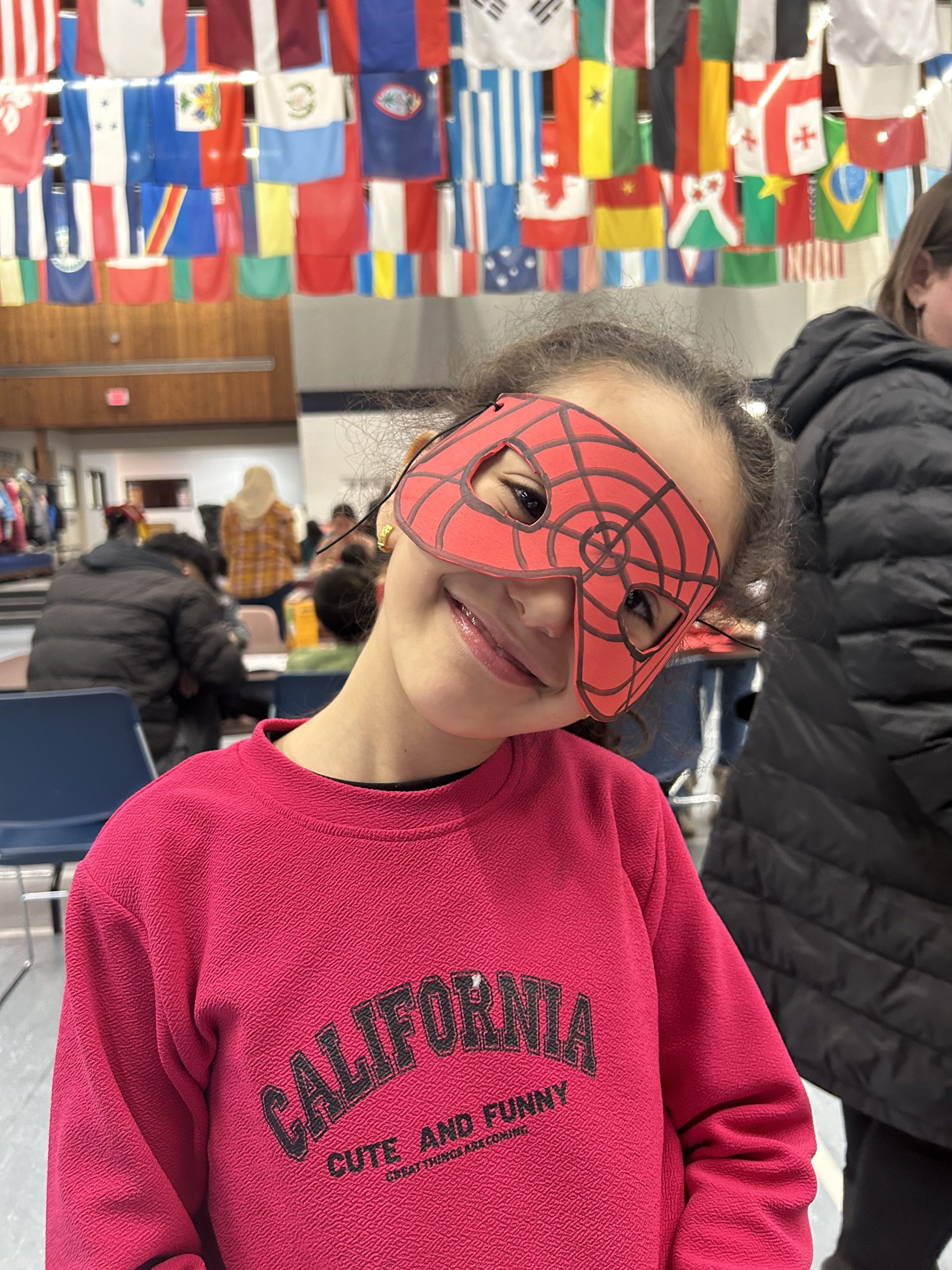 Young girl with homemade spiderman mask on