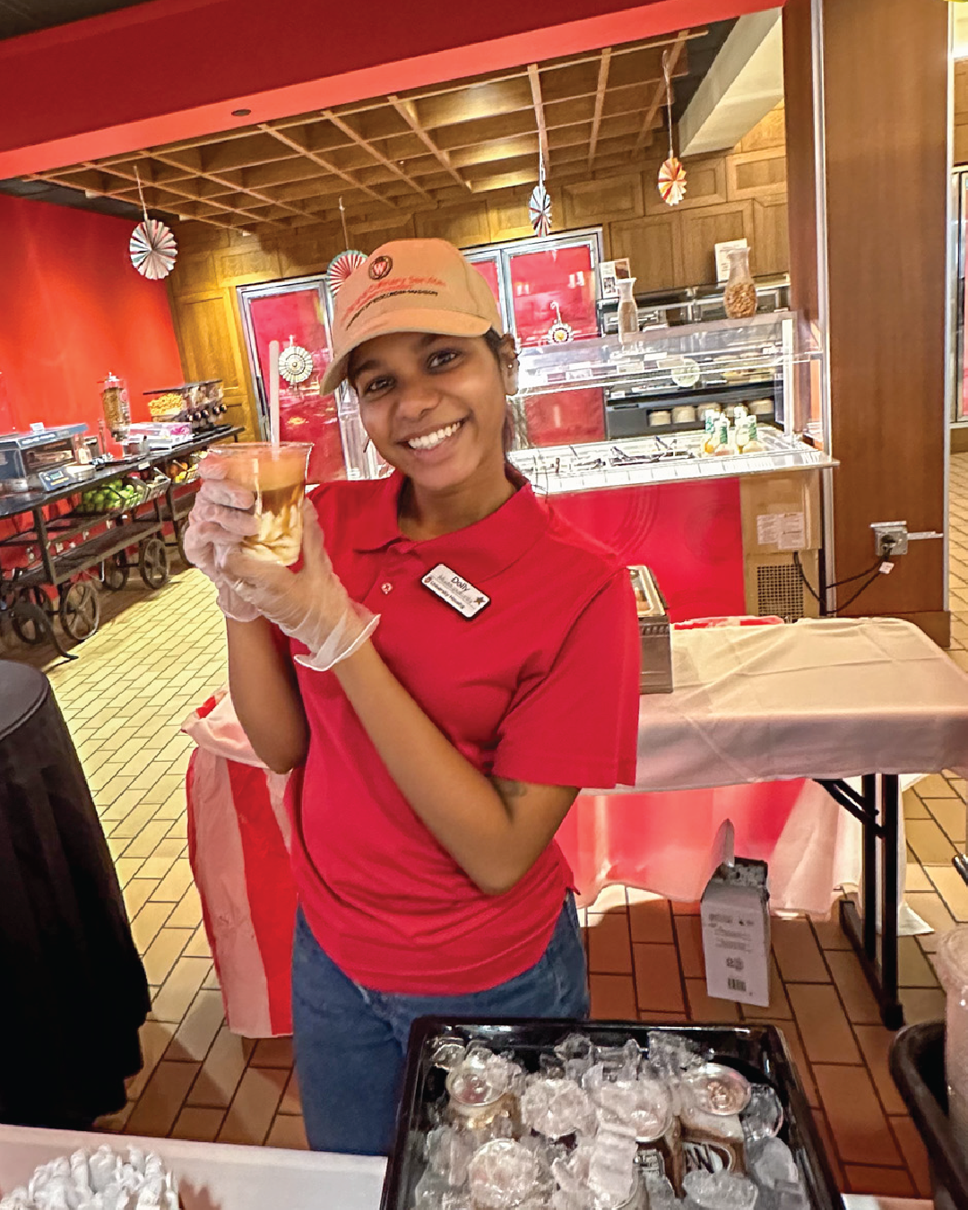 Staff member posing with root beer float at Carson's Market for Carson's Fair