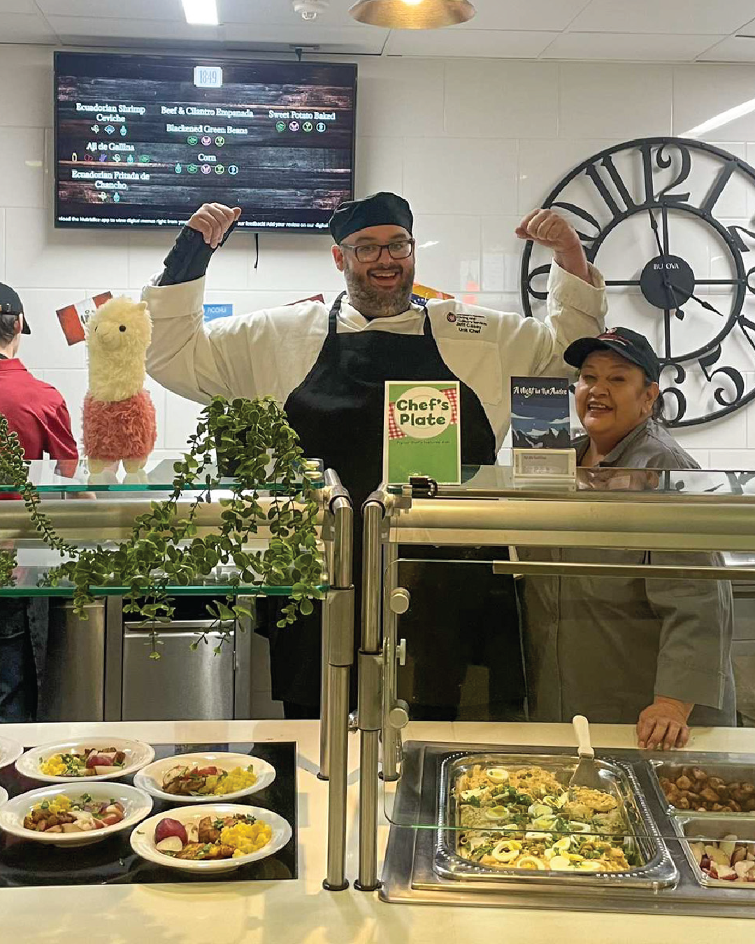 Staff members pose in front of special event food