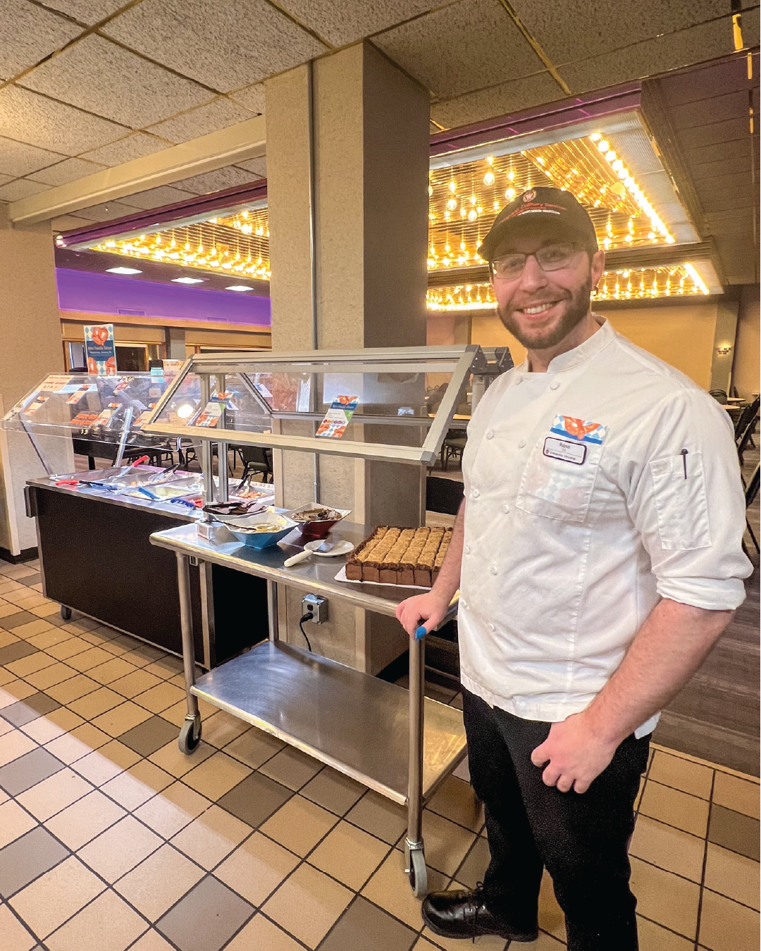 Chef Ross posing with his family dinner lineup