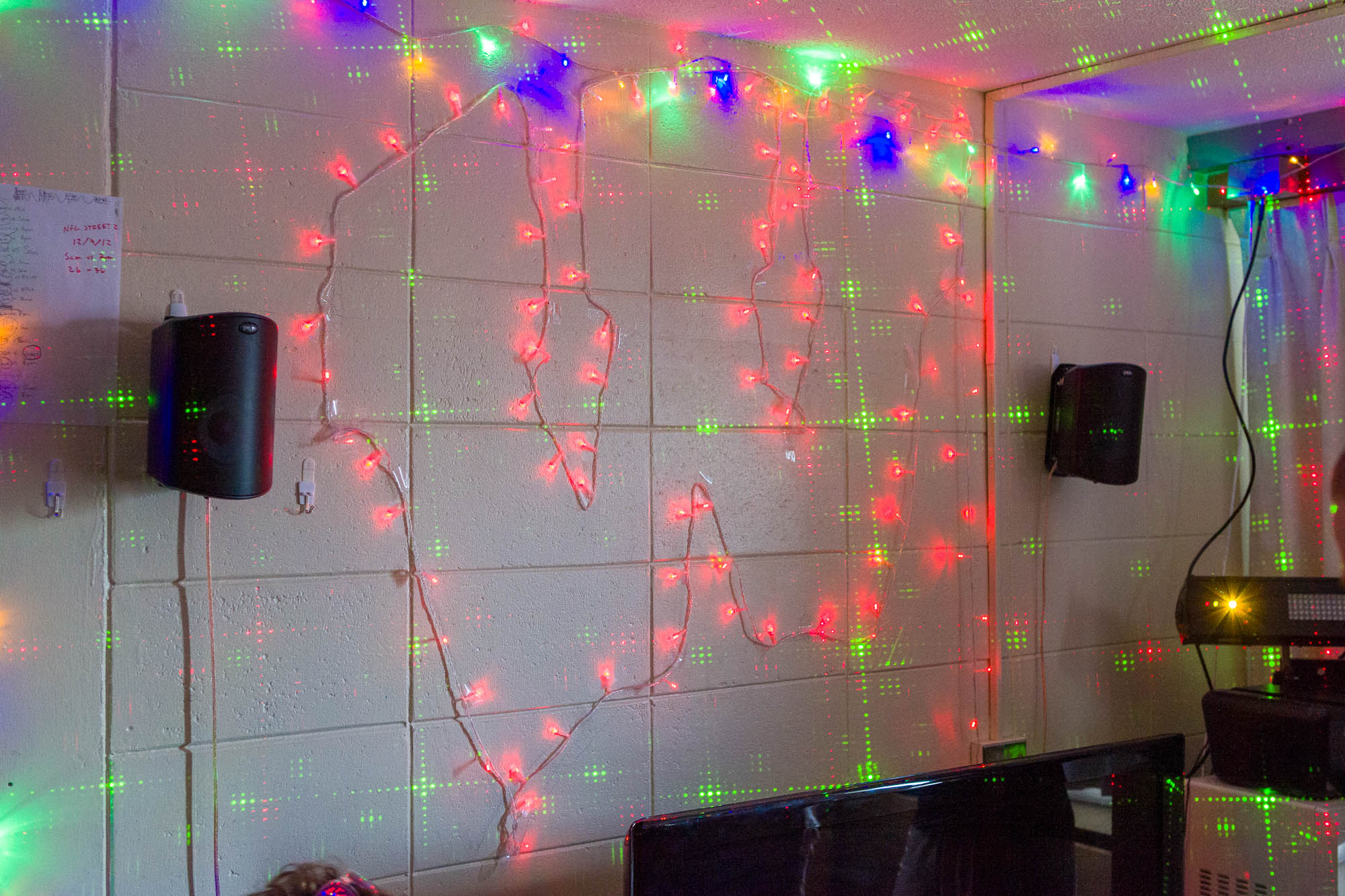 A Motion W logo made out of string lights in a double room in Sellery Residence Hall in 2013