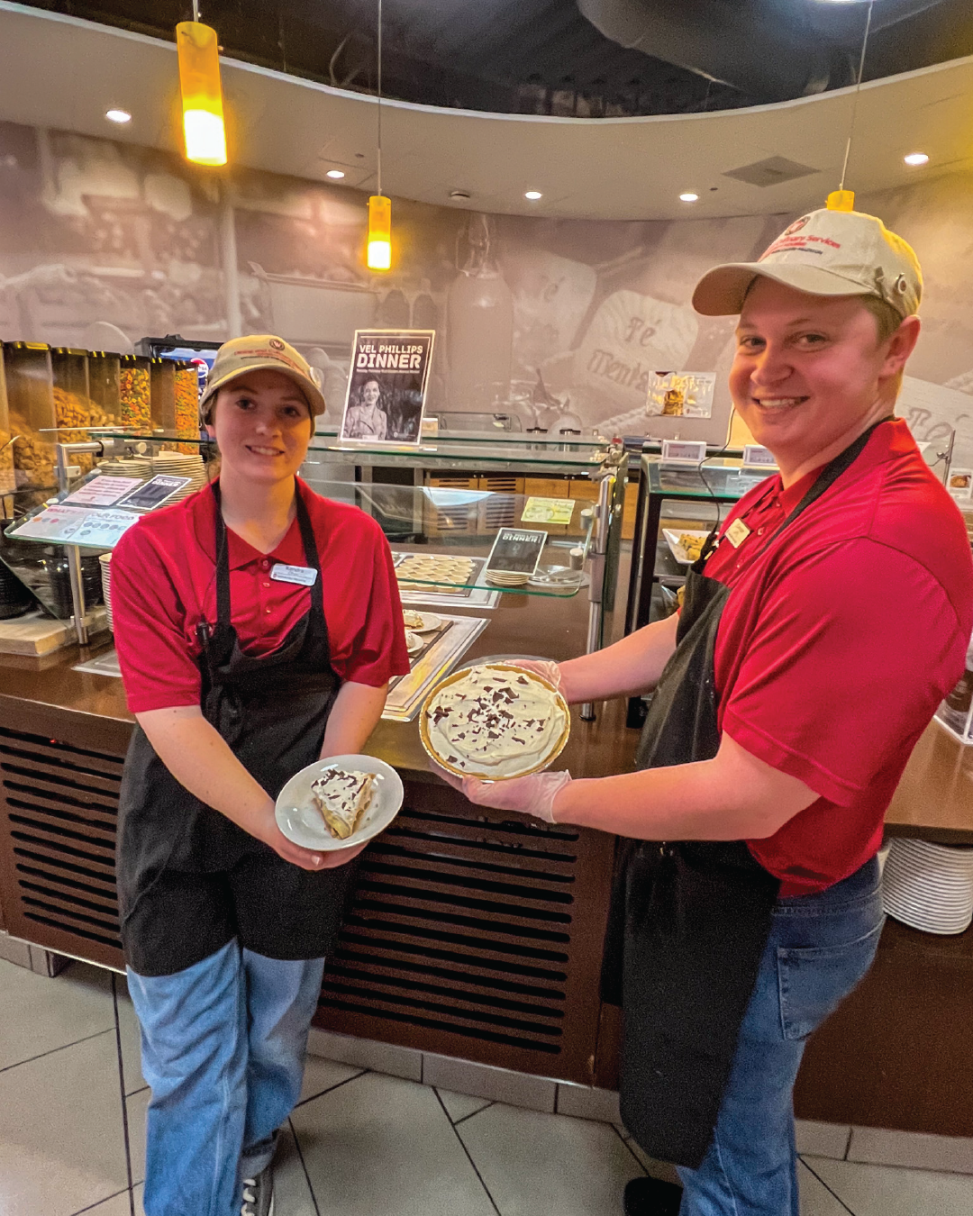 Two student staff members pose with Fudge Bottom Cake