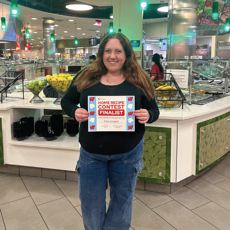 2025 Home Recipe Contest Finalist - Ellen D posing in Gordon Ave Market with certificate