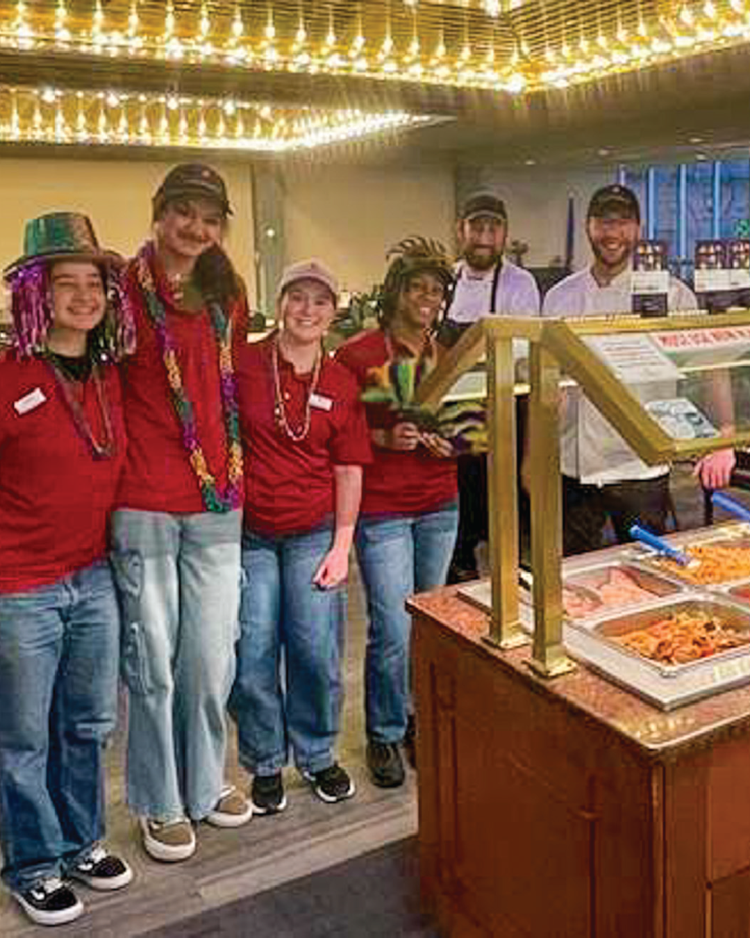 Dining staff posing for Mardi Gras