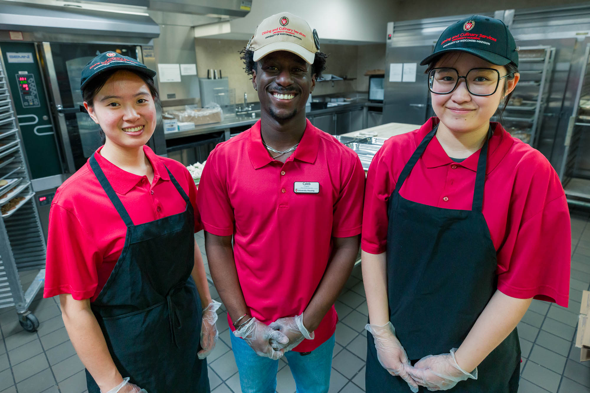 Caleb Davis poses for a photo with two student employees in Gordon Avenue Market.