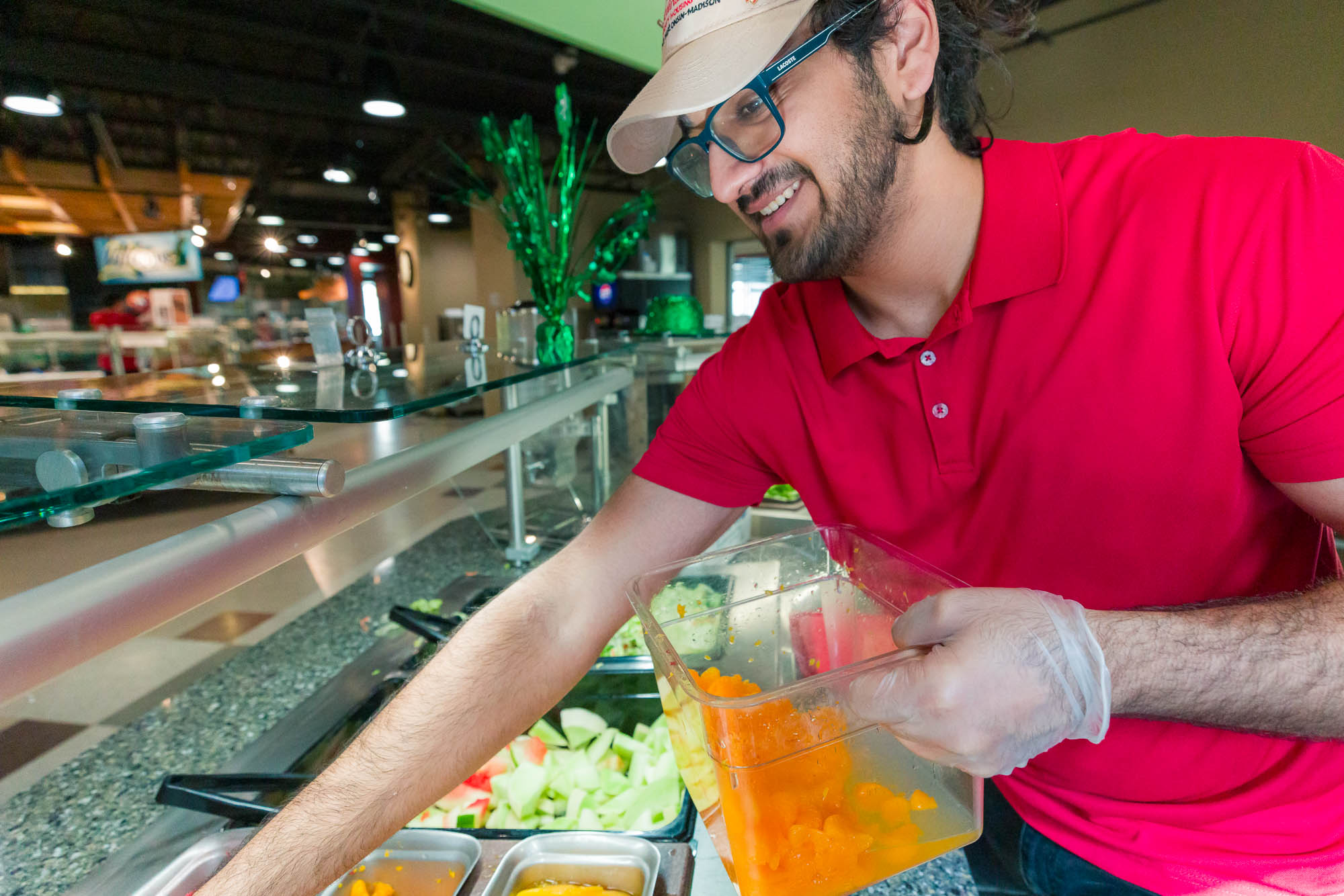 Kshitij Pandey restocks fruit at the Great Greens station in Rheta's Market.