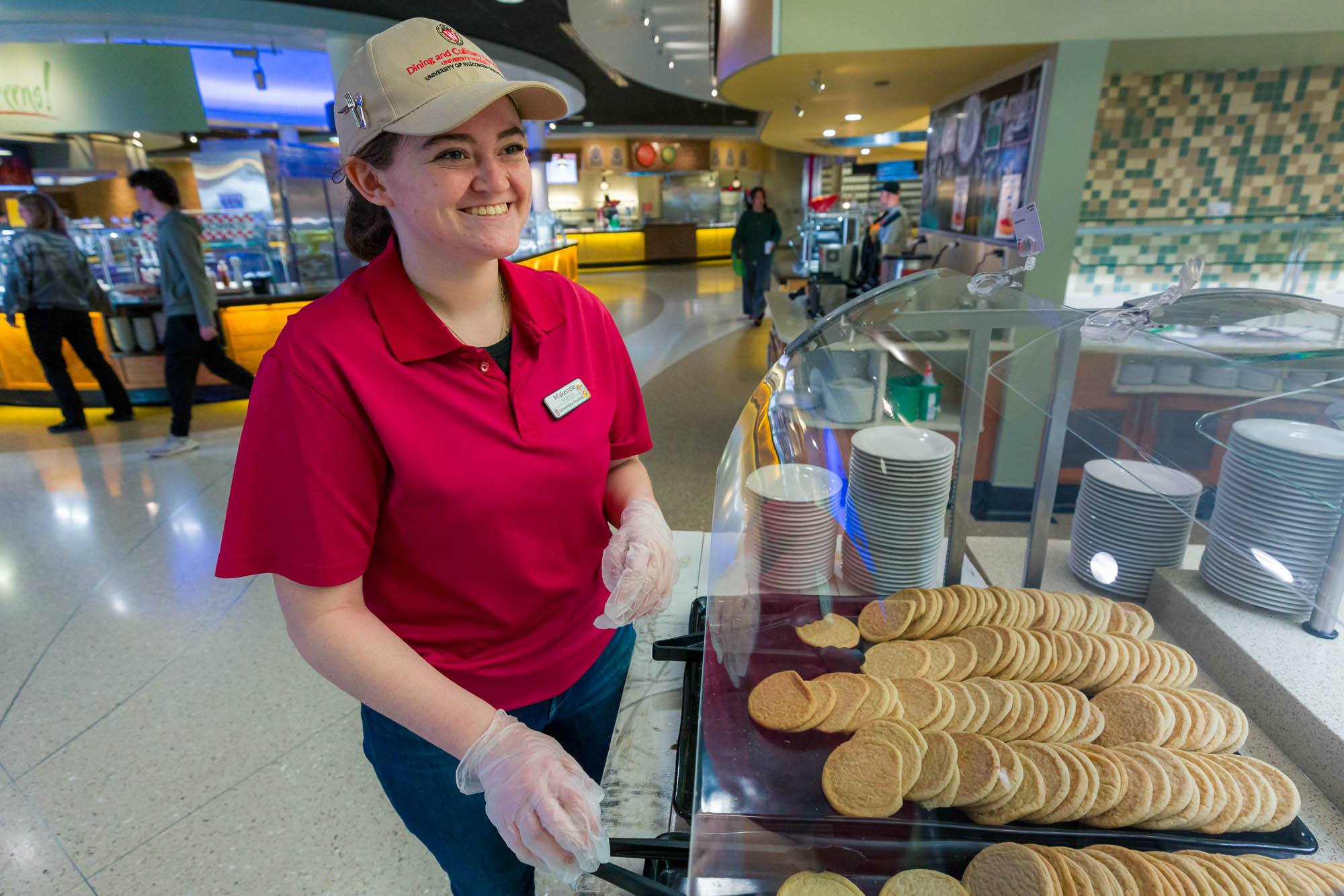 Makenzie Mathys arranges cookies in Four Lakes Market.
