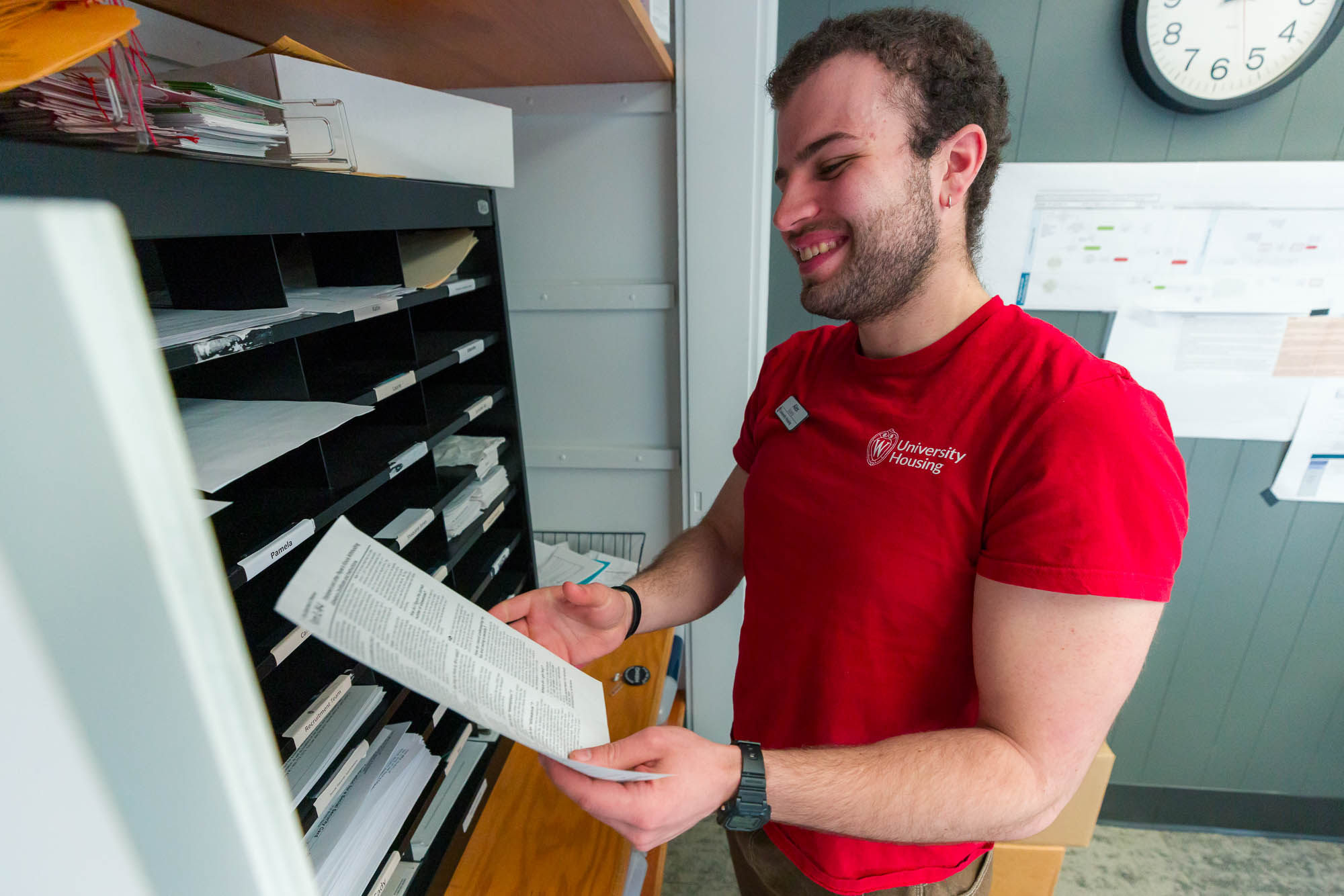 Alex Koory looks at a form in the Human Resources office in Slichter Residence Hall.