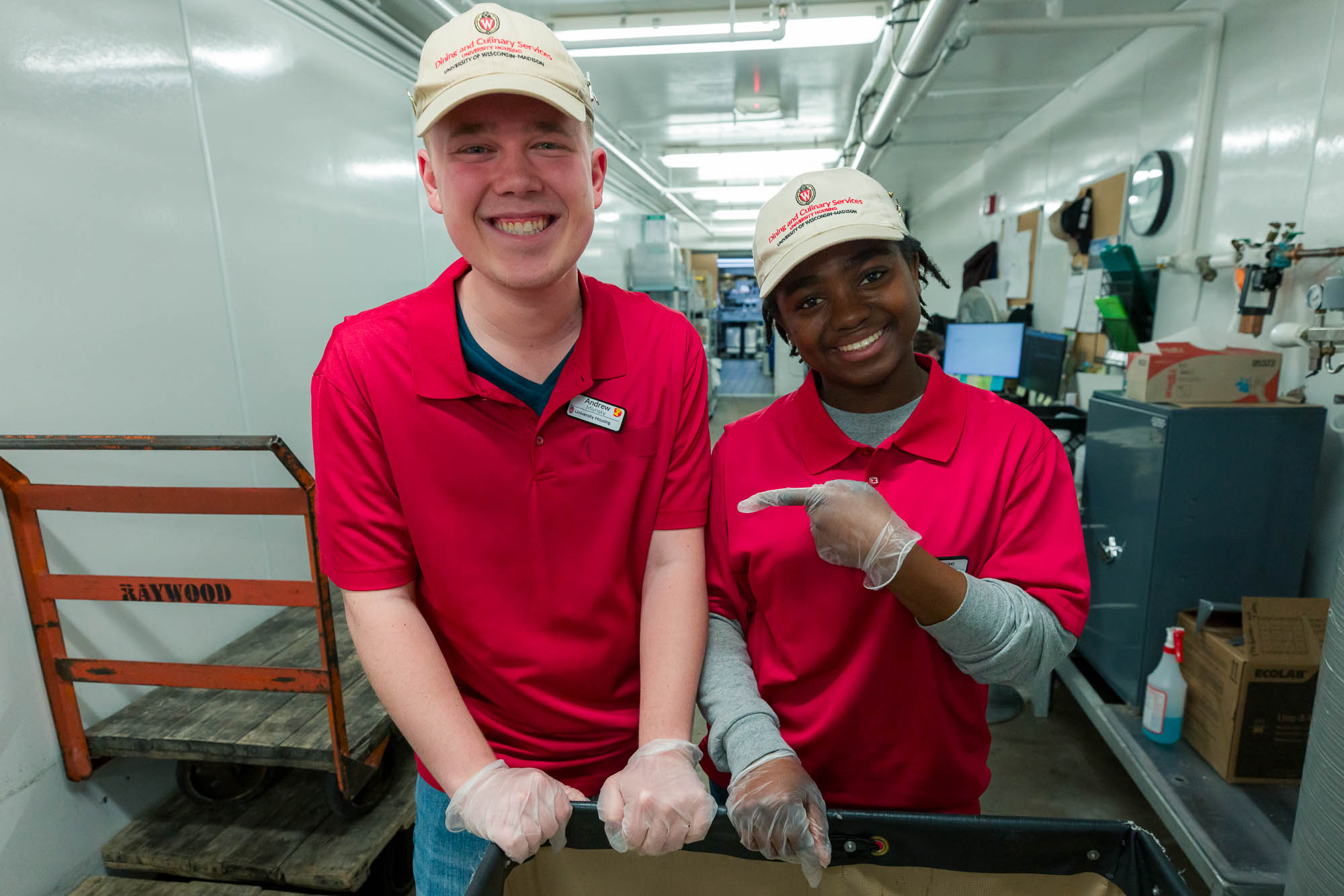 Andrew Mylnsky poses for a photo with another student employee in the Liz's Market loading dock.