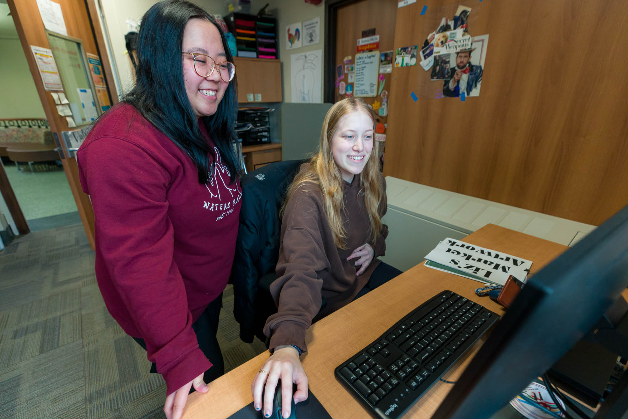 Carol Sze looks at a computer screen in the Residence Life Office (RLO) in Waters Residence Hall.