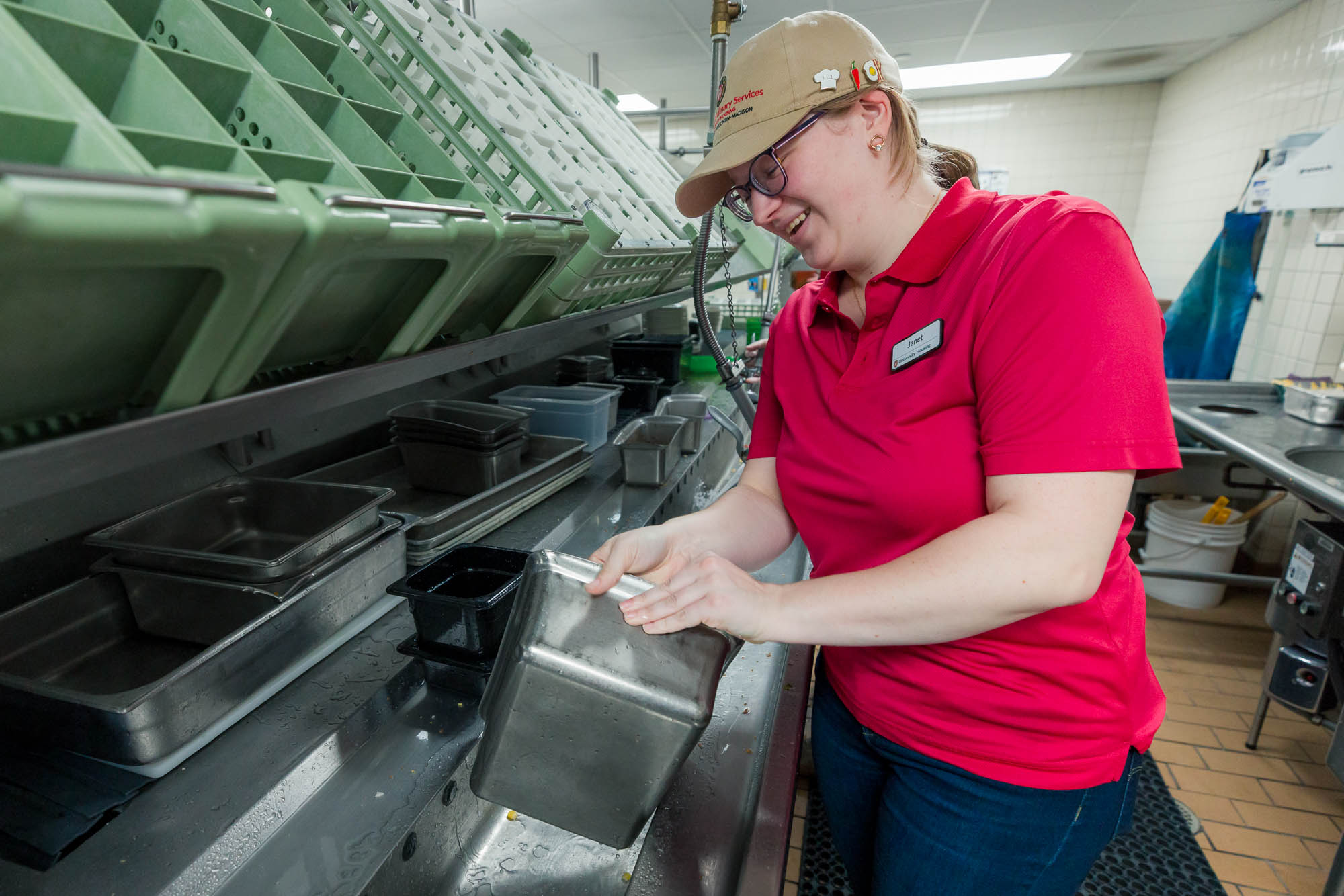 Janet Seidl washes a container in the dishroom at Carson's Market.