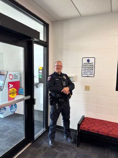 Officer Kirchaman standing inside next to the IPEL sign