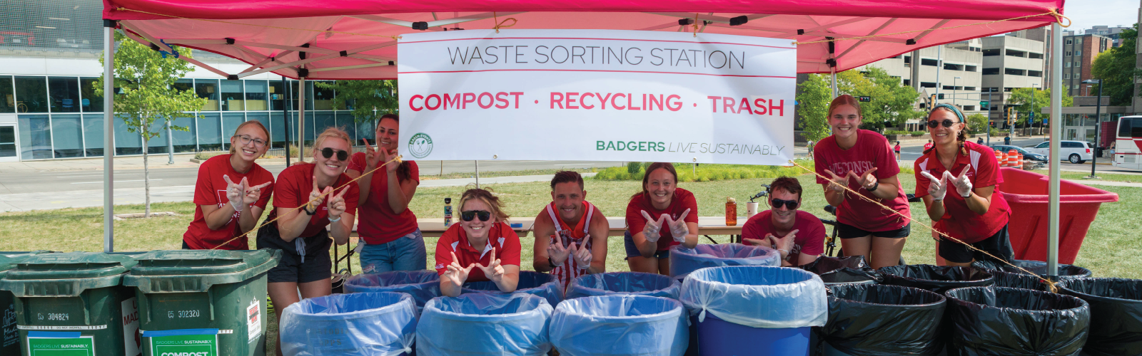 sustainability staff and students posing by the waste sorting station