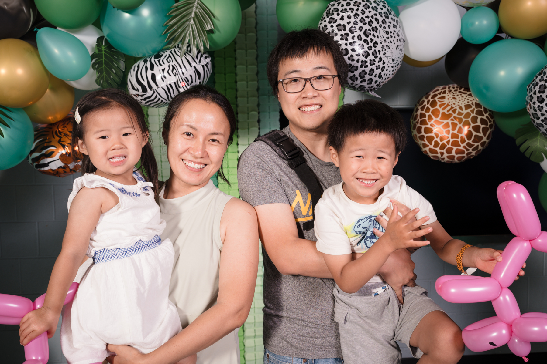 Family of four with two kids smiling at camera