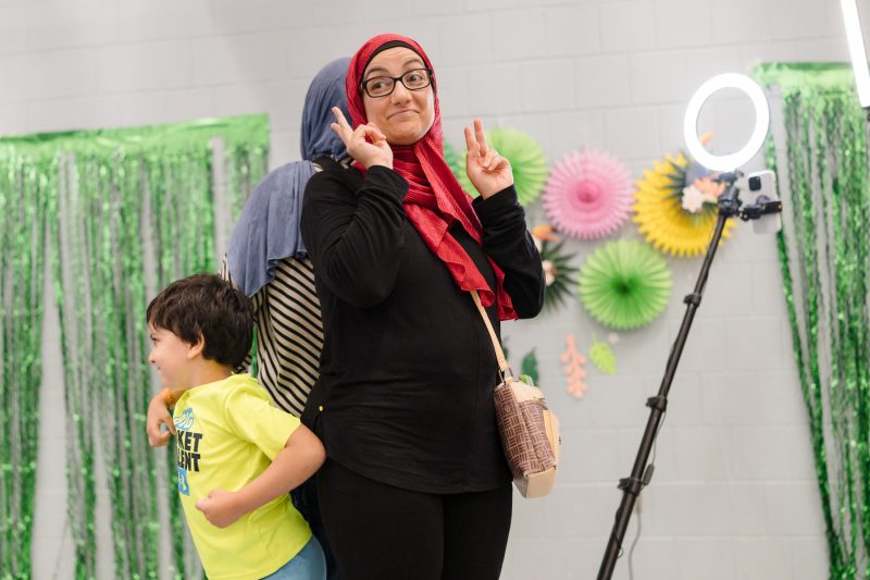 Women giving the peace sign while smiling