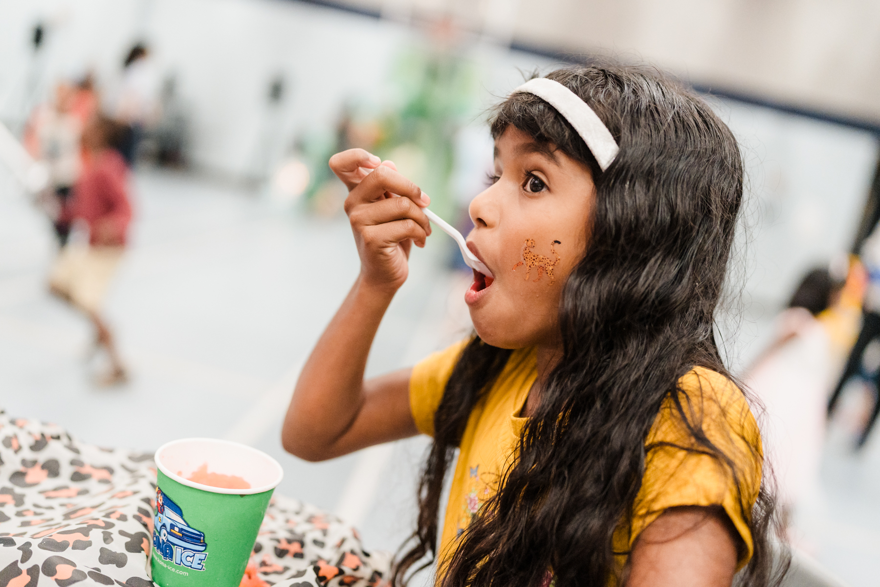 Young girl eating Kona Ice