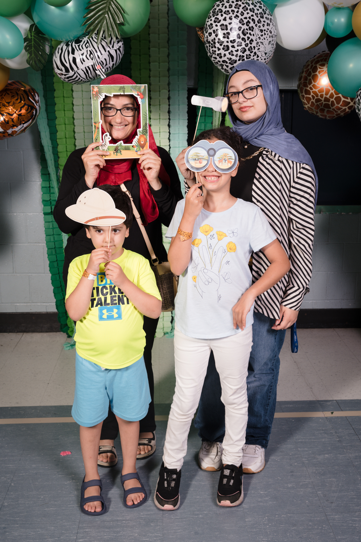 Two adults and two kids with photo props