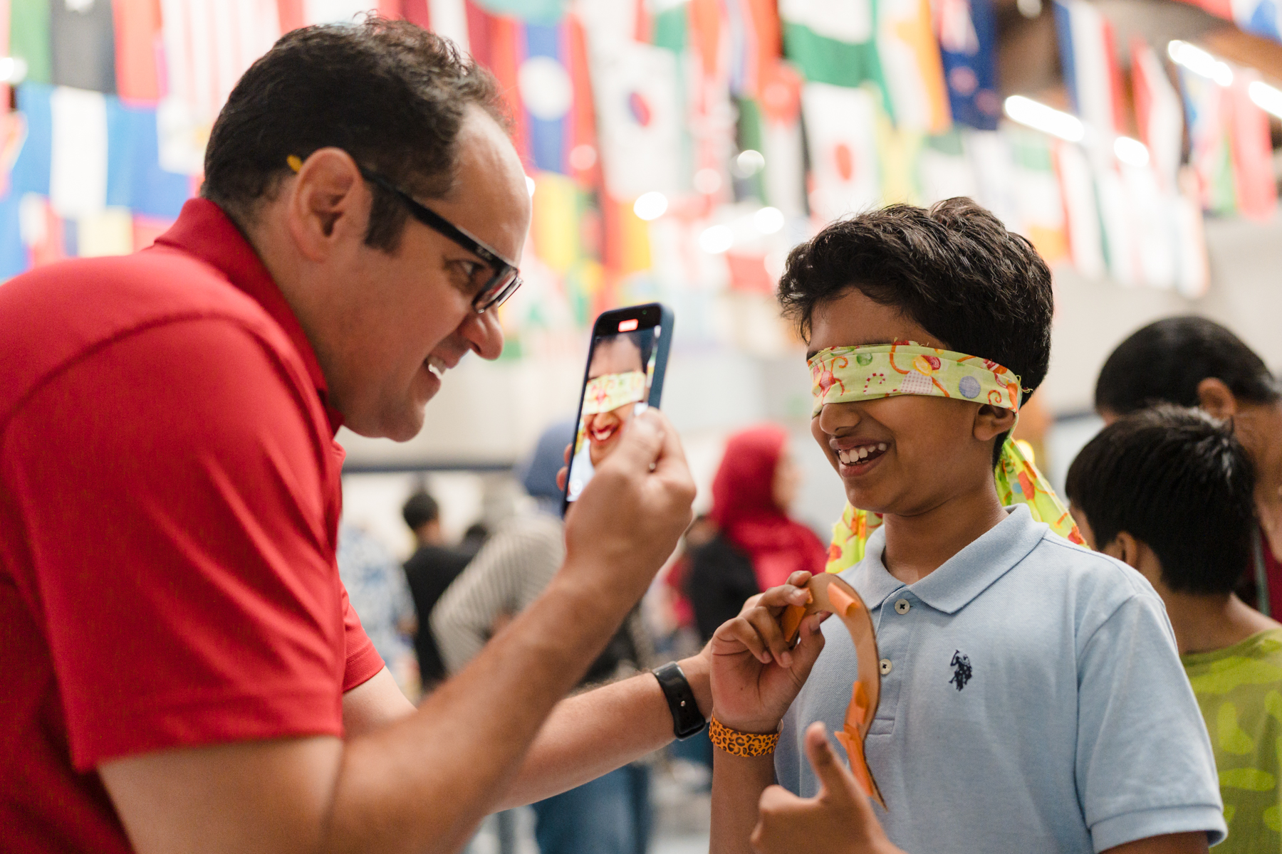 Kid smiling while blindfolded playing game