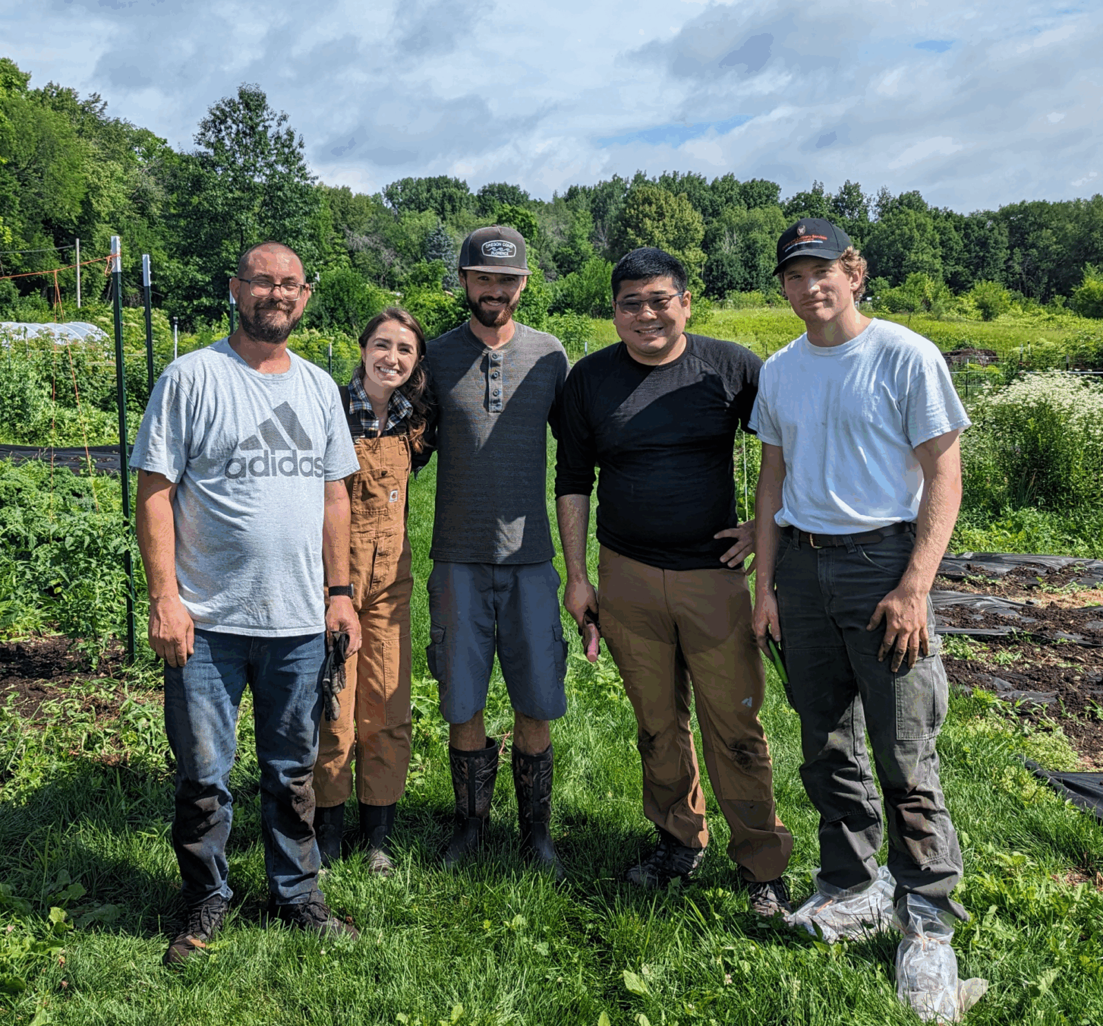 Campus Farm staff pose for photo at the farm
