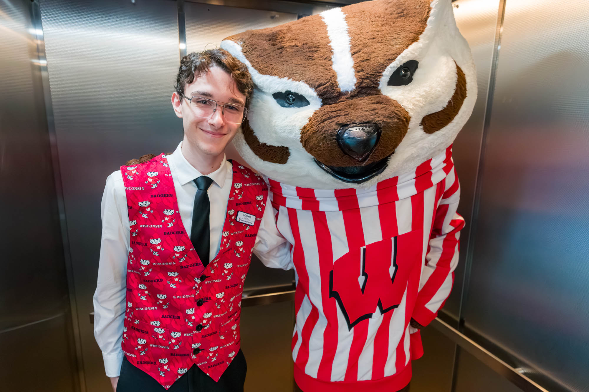 One person posing with Bucky inside an elevator