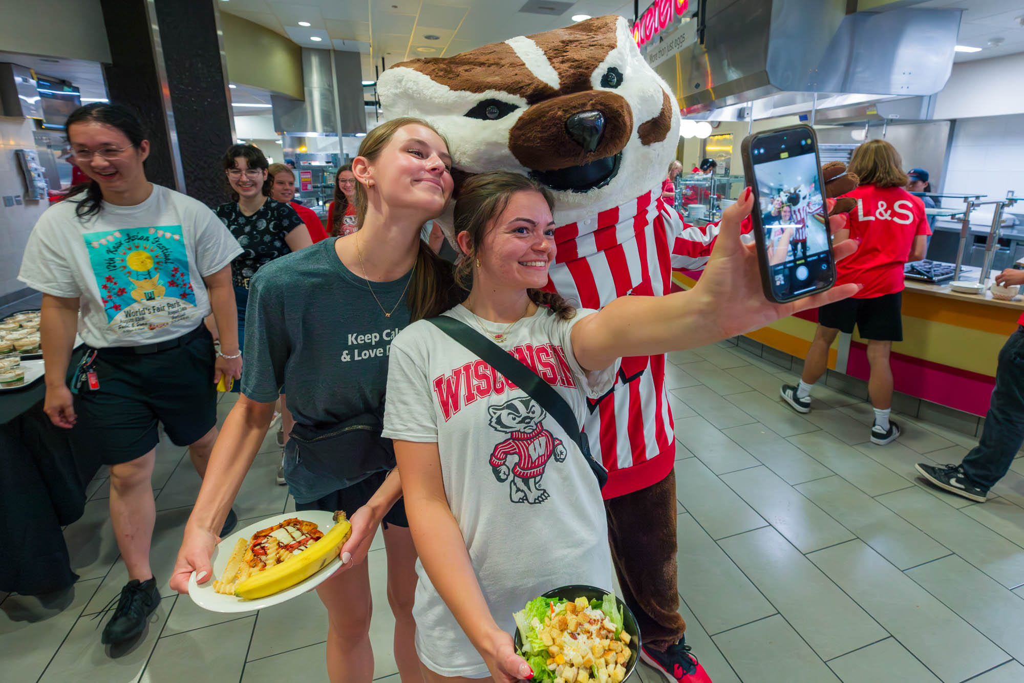 Two people take a selfie with Bucky