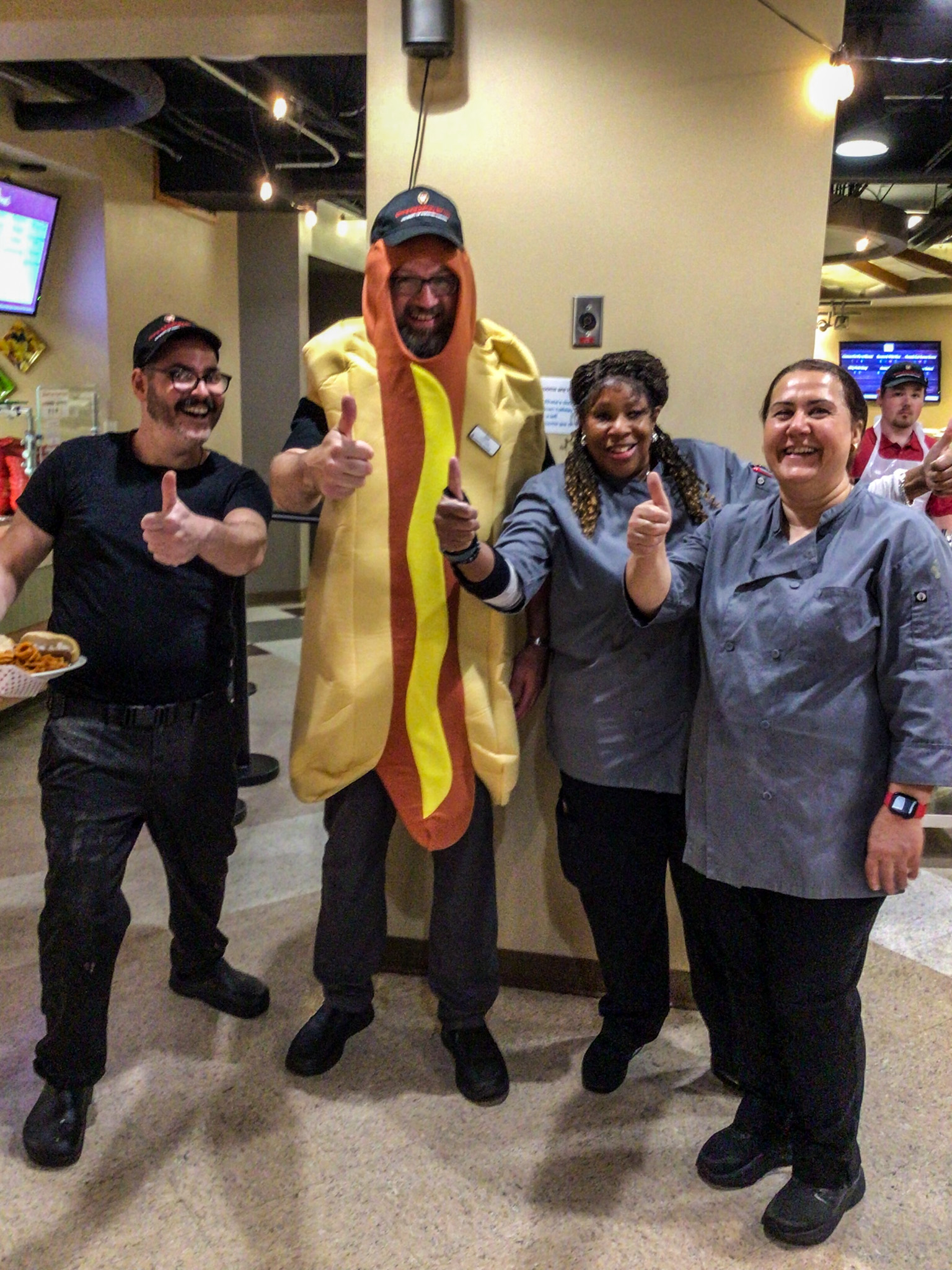 Dining staff pose for National Hot Dog Day