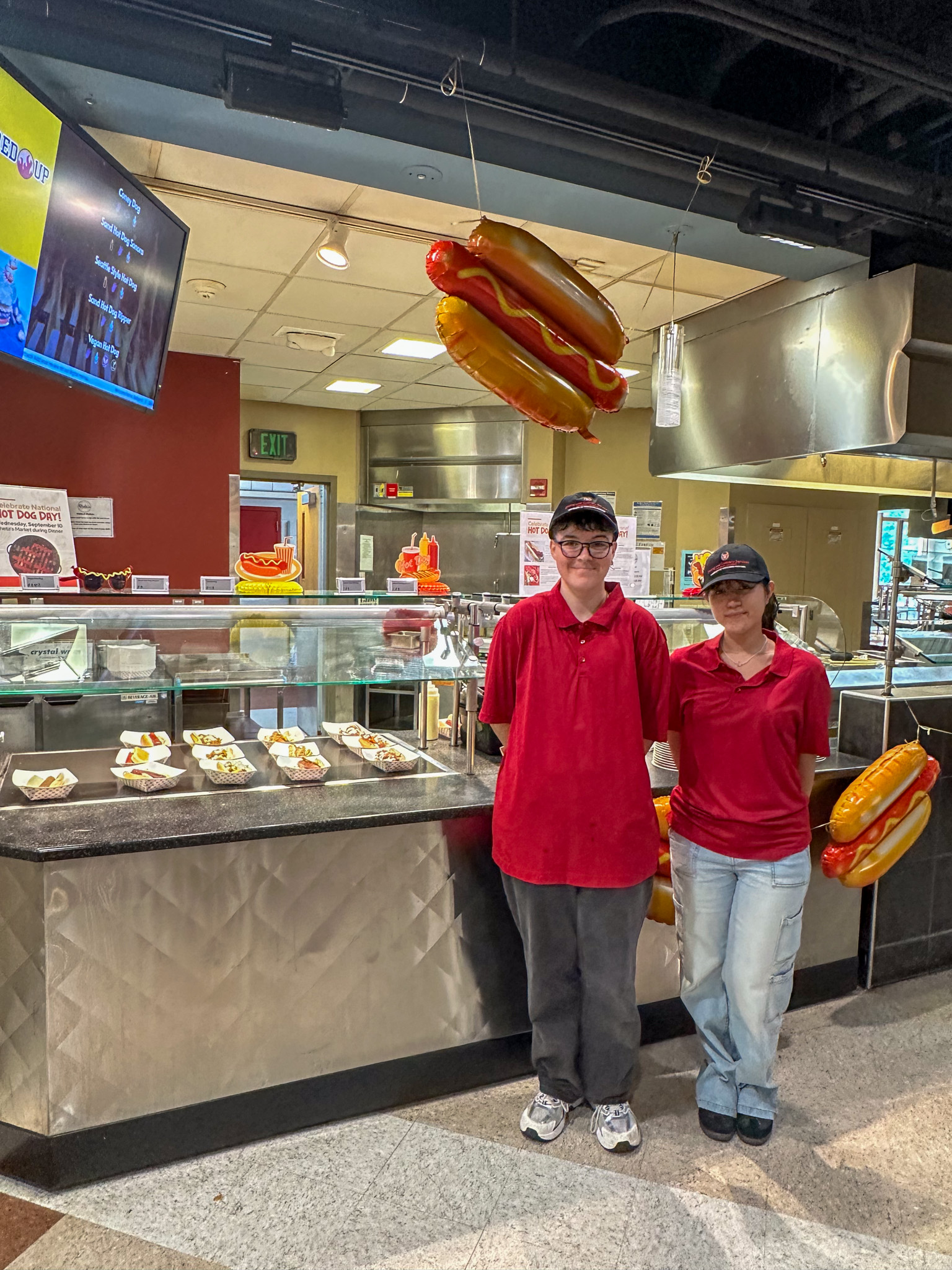 Dining staff pose for National Hot Dog Day