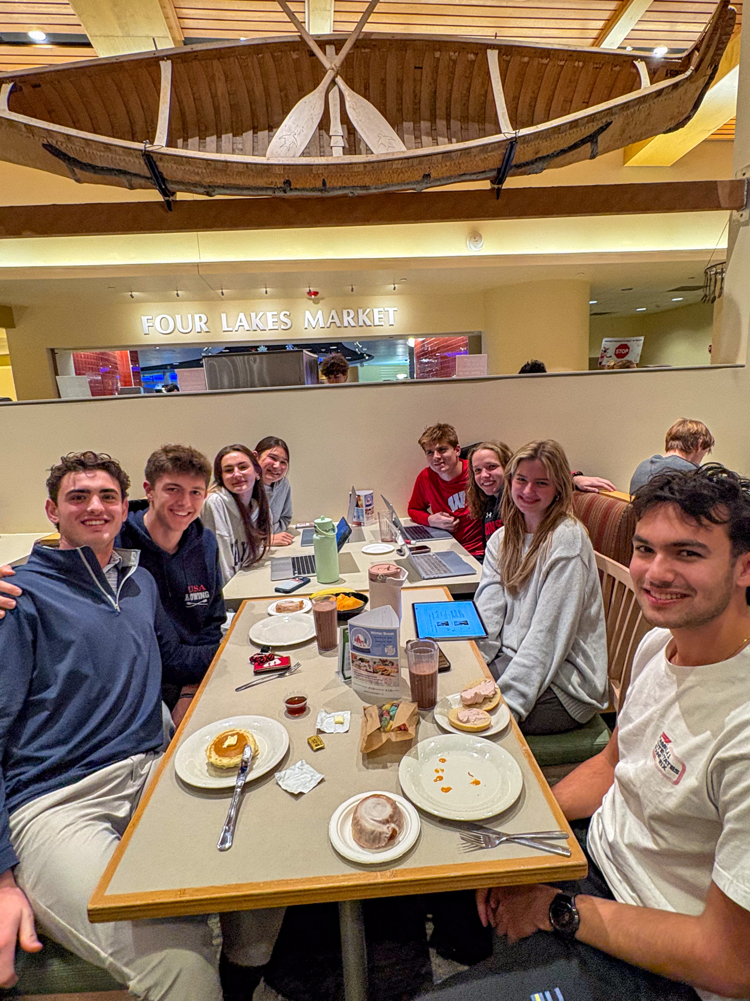 Group of students pose for photo at their table during Late Night Breakfast