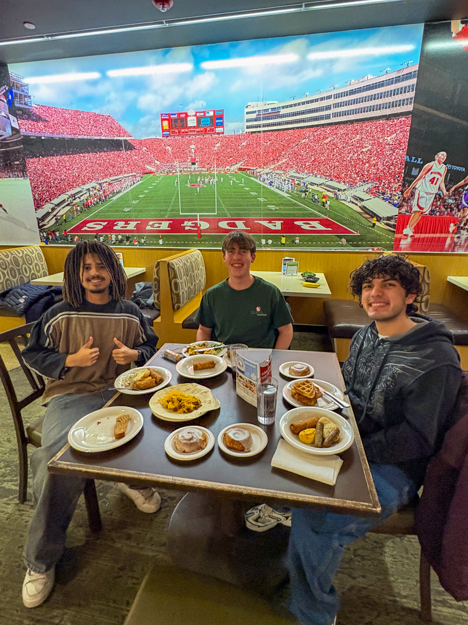 Group of students pose for photo at their table during Late Night Breakfast