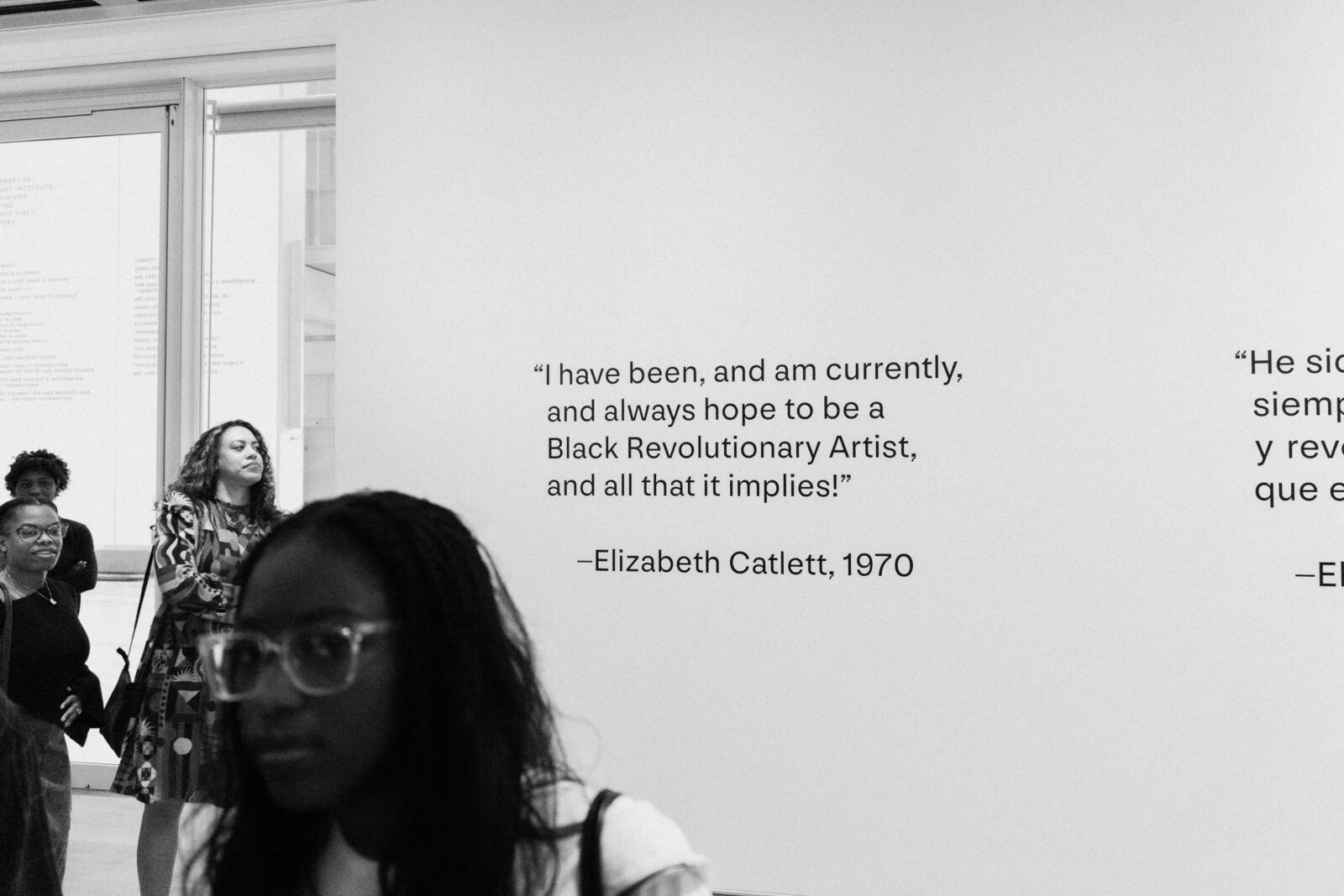 A quote at an art gallery reading: "I have been, and am currently, and always hope to be a Black Revolutionary Artist, and all that it implies!" attributed to Elizabeth Catlett in 1970