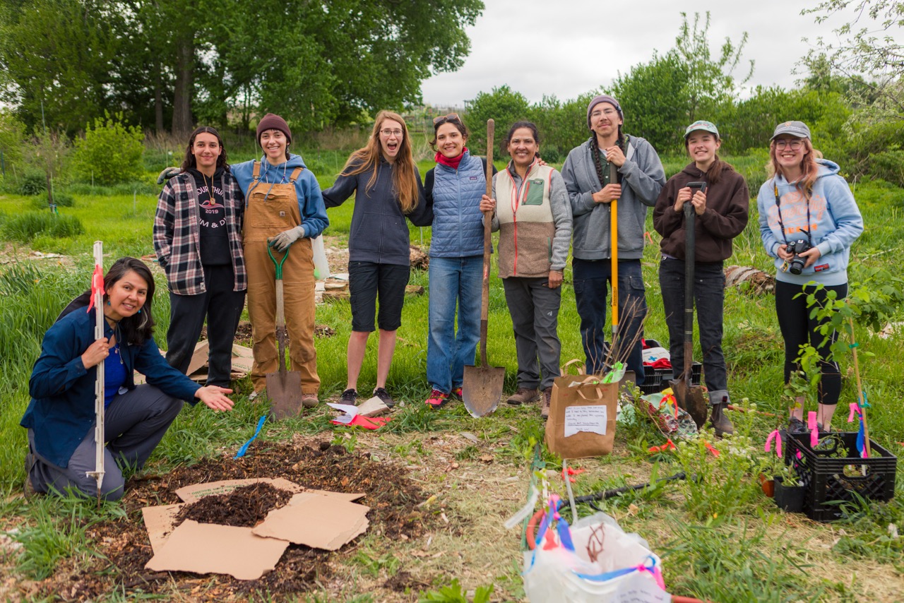Students pose for group photo at the campus farm during planting day