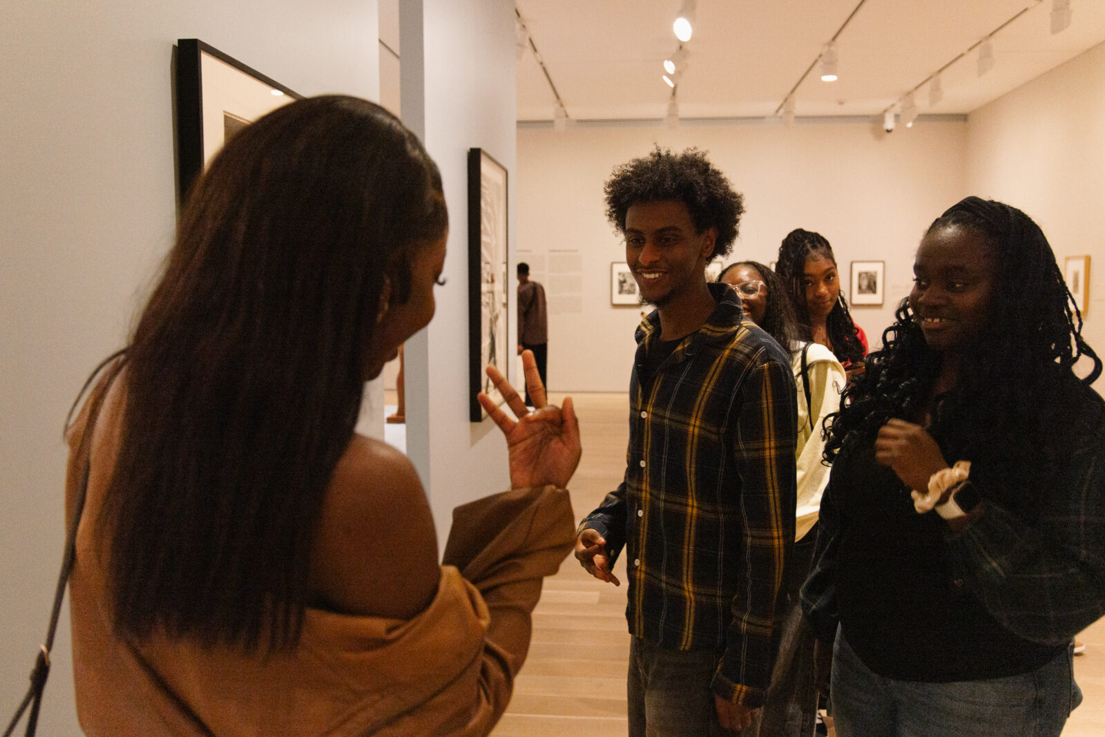 Three people talking in an art gallery