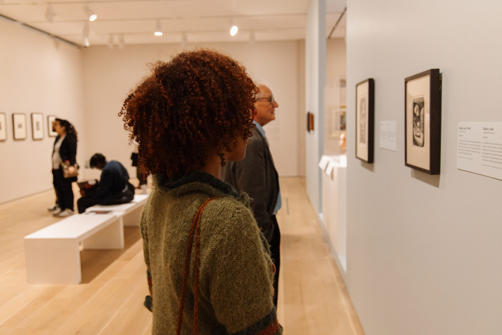 Two people looking at artwork in an art gallery.