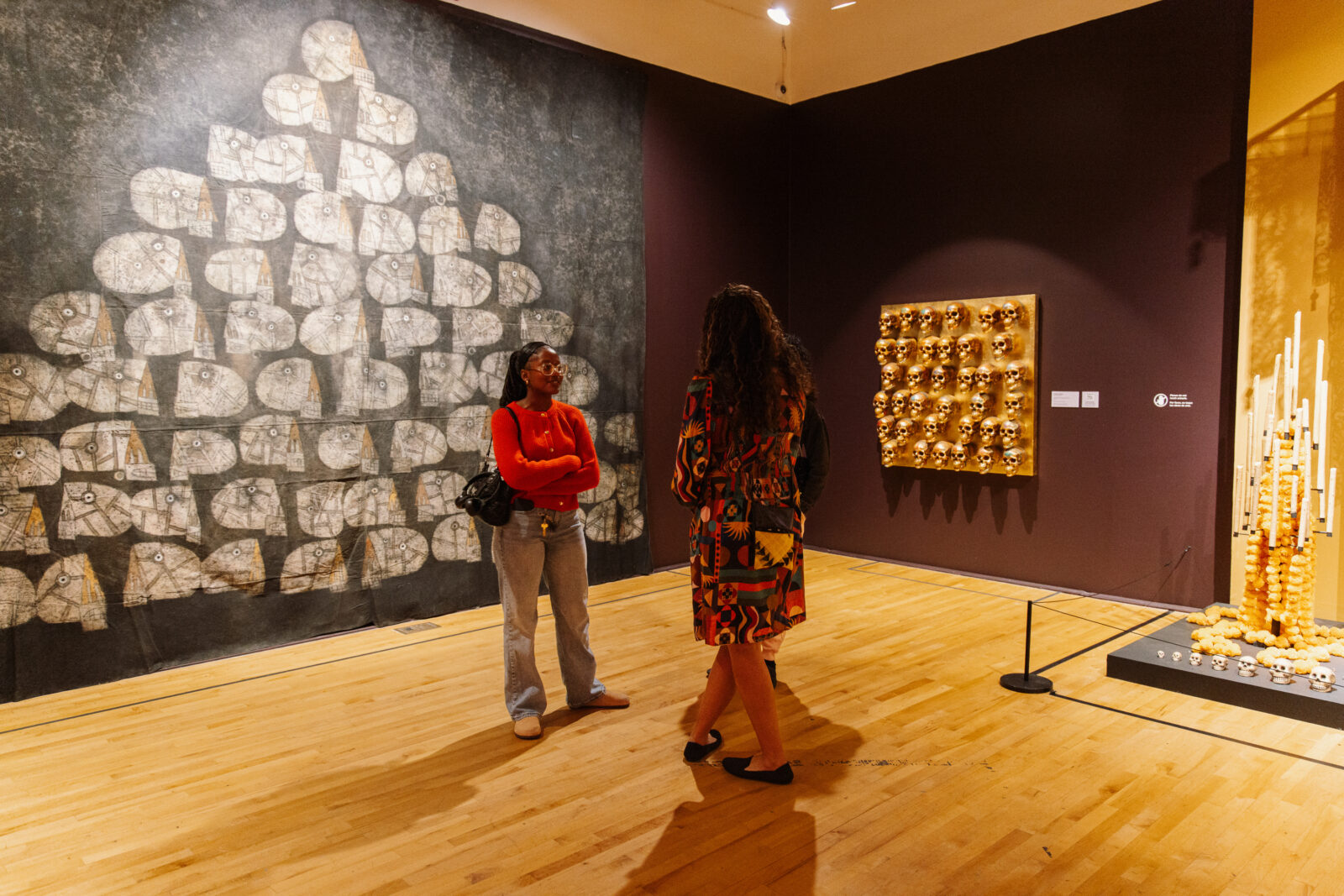 Two people talking in an art gallery