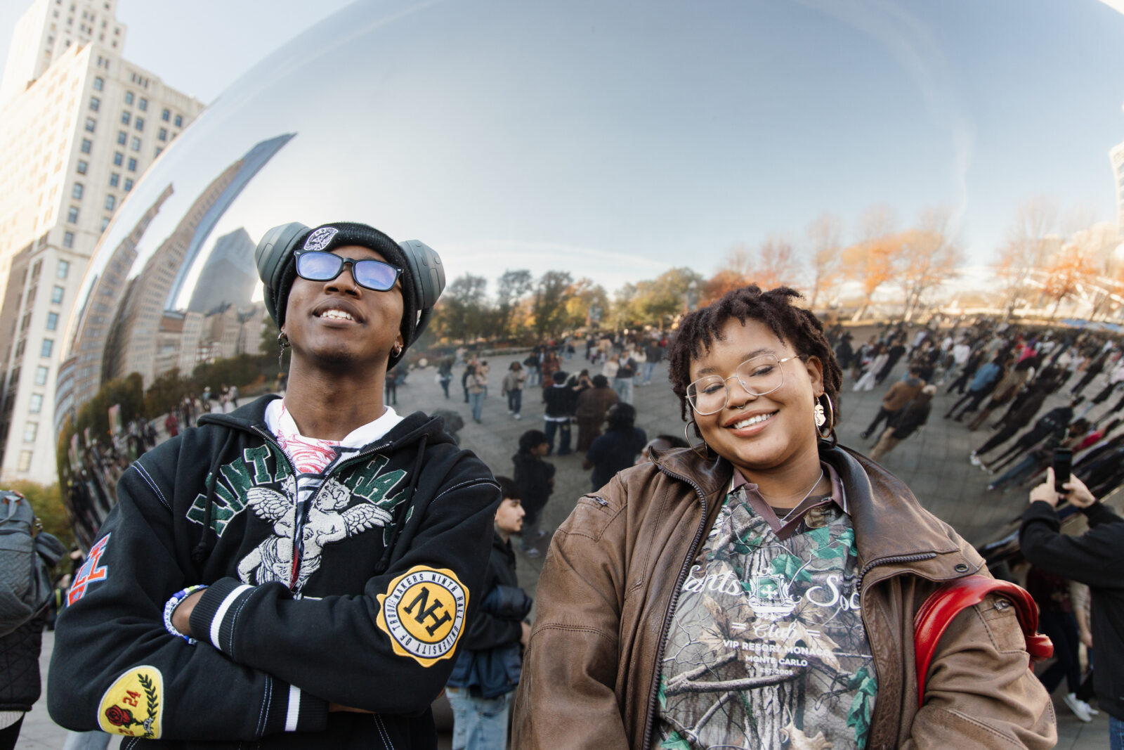 Two people posing in front of The Bean in Chicago, Illinois.
