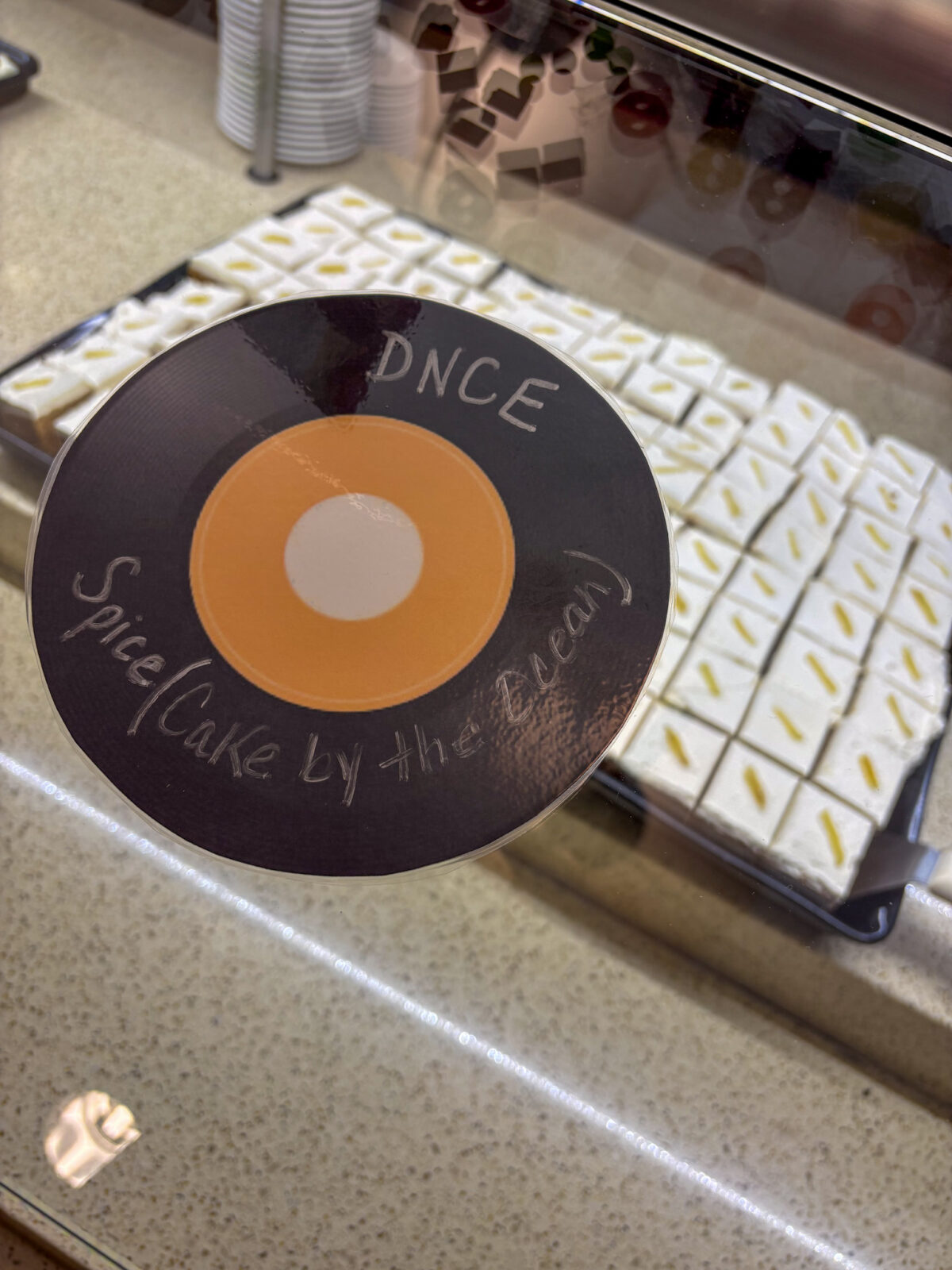 DNCE Spice Cake by the Ocean record sign with spice cake in background