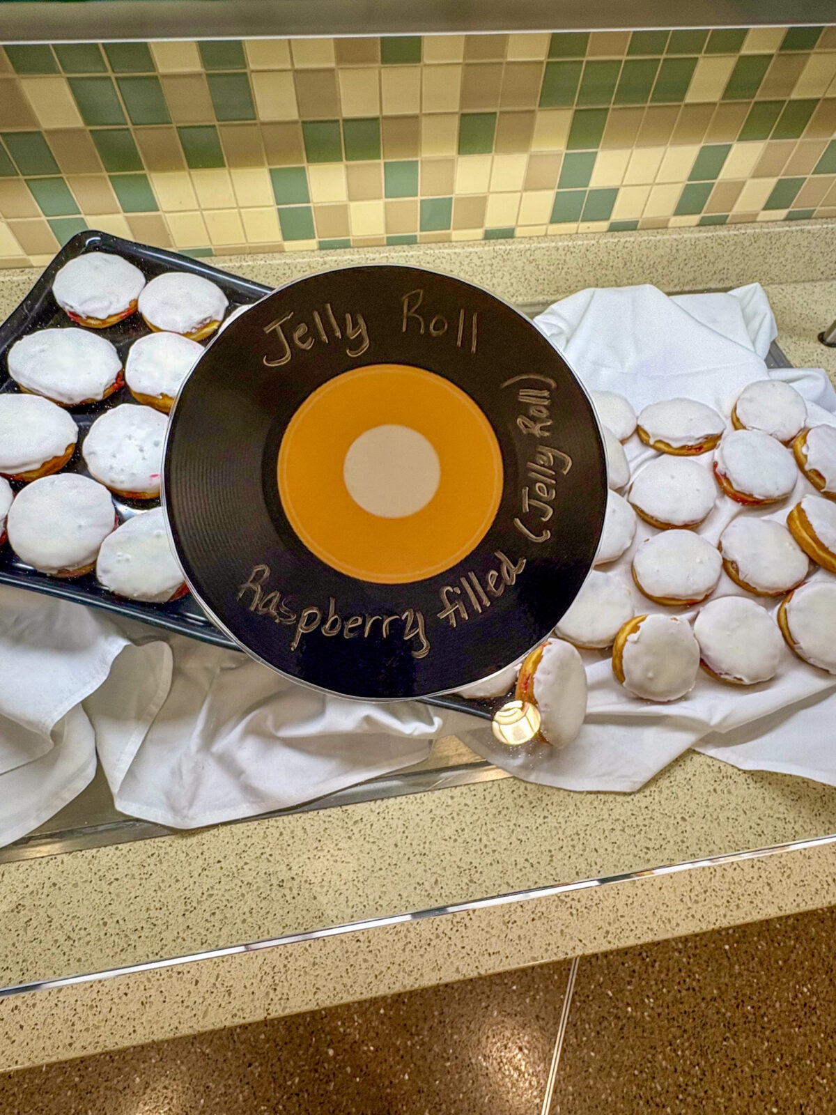 Jelly Roll record sign with raspberry filled jelly roll in the background