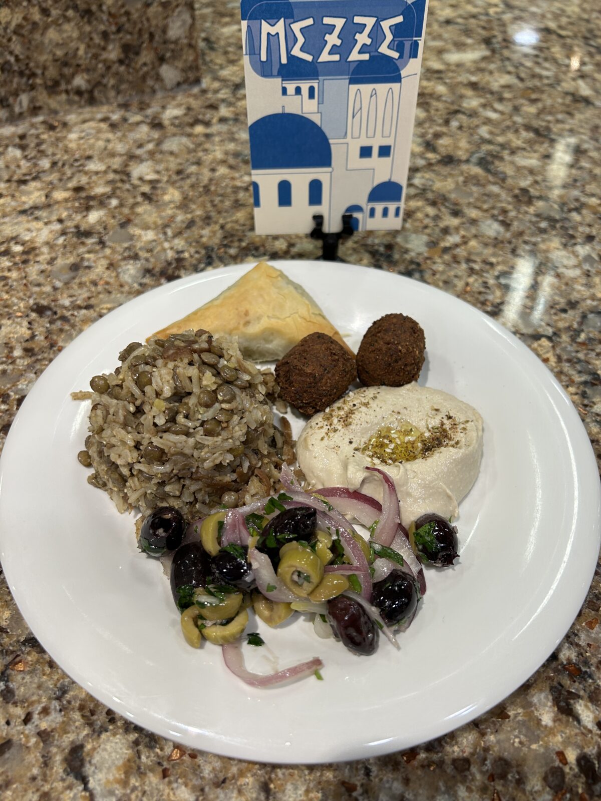 Plate of mezze food with sign