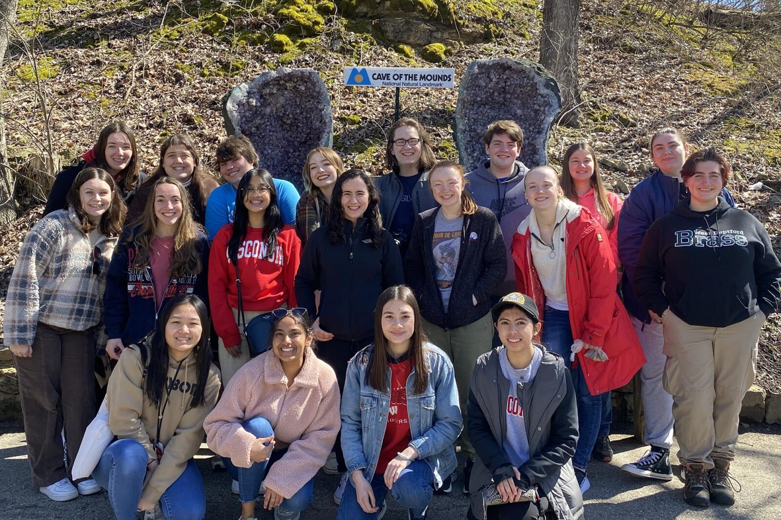 A large group poses in front of Cave of the Mounds.