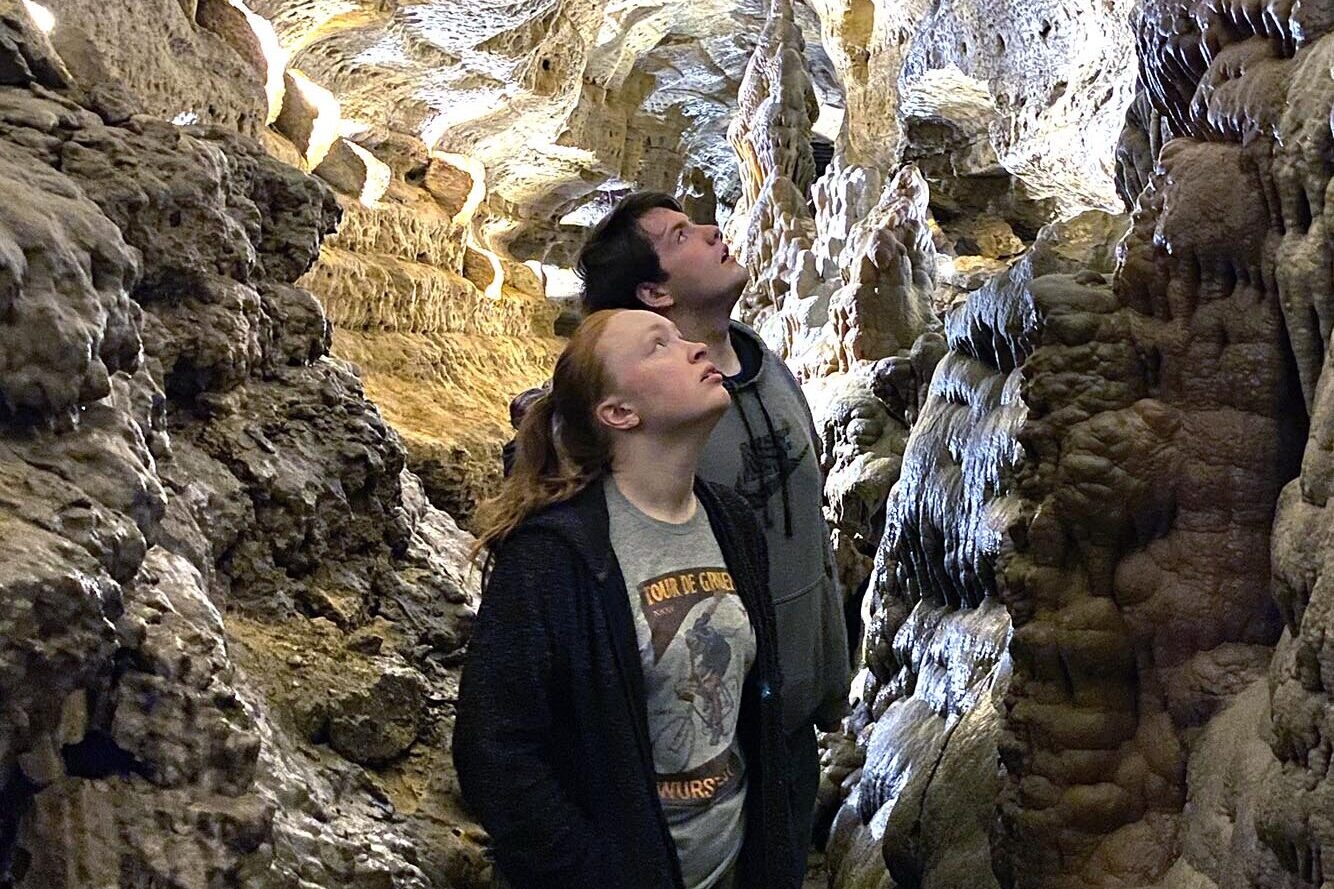 Two people look up at the cave formations in the Cave of the Mounds.