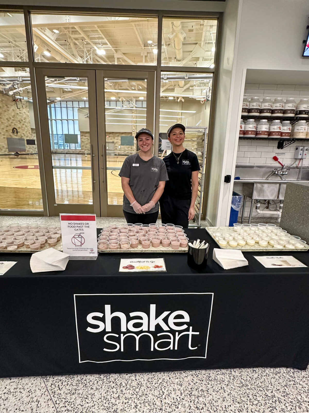 Student staff pose for photo at shake smart's free samples at Bakke for Active Badger Day