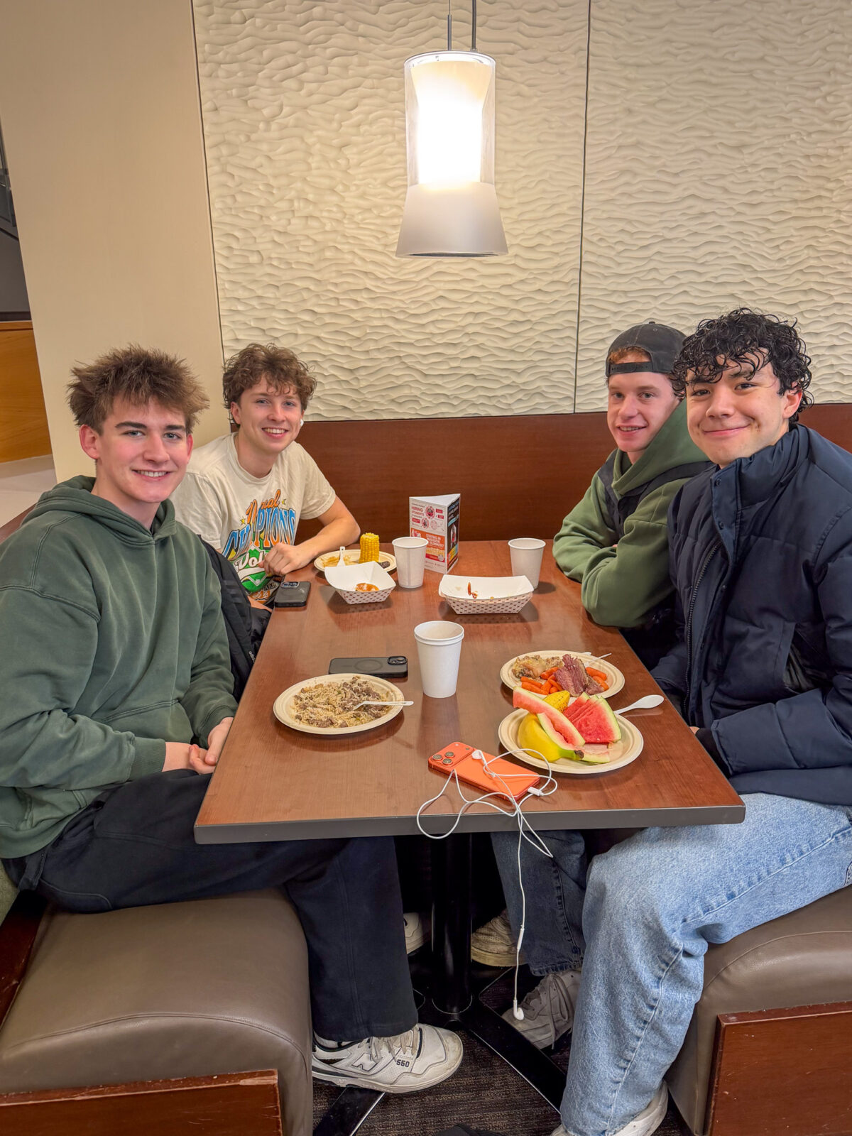 Group of students dining at St. Patrick's day event pose for photo
