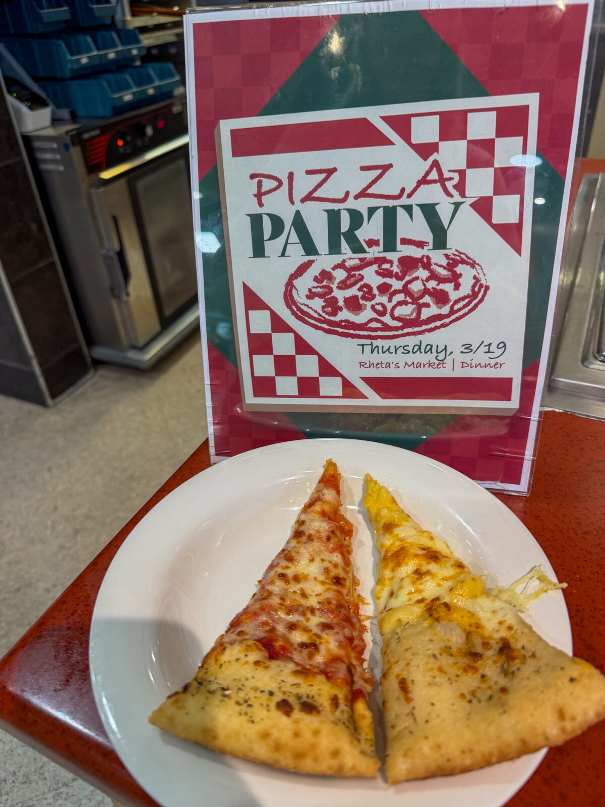 Special pizza at dining's Pizza Party day event with sign in back