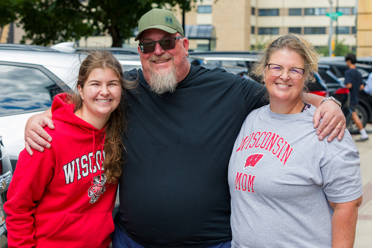 Family on move-in day wearing UW-Madison merch.