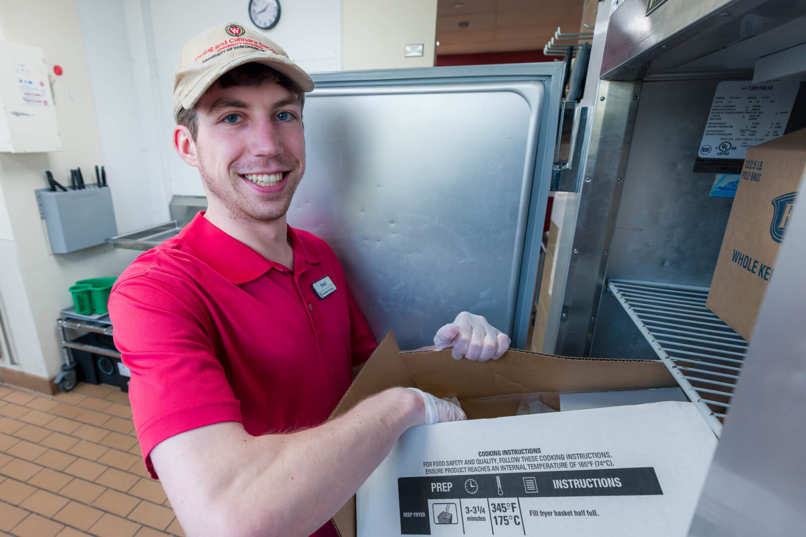 Reed opens a box in a freezer at Carson's Market.